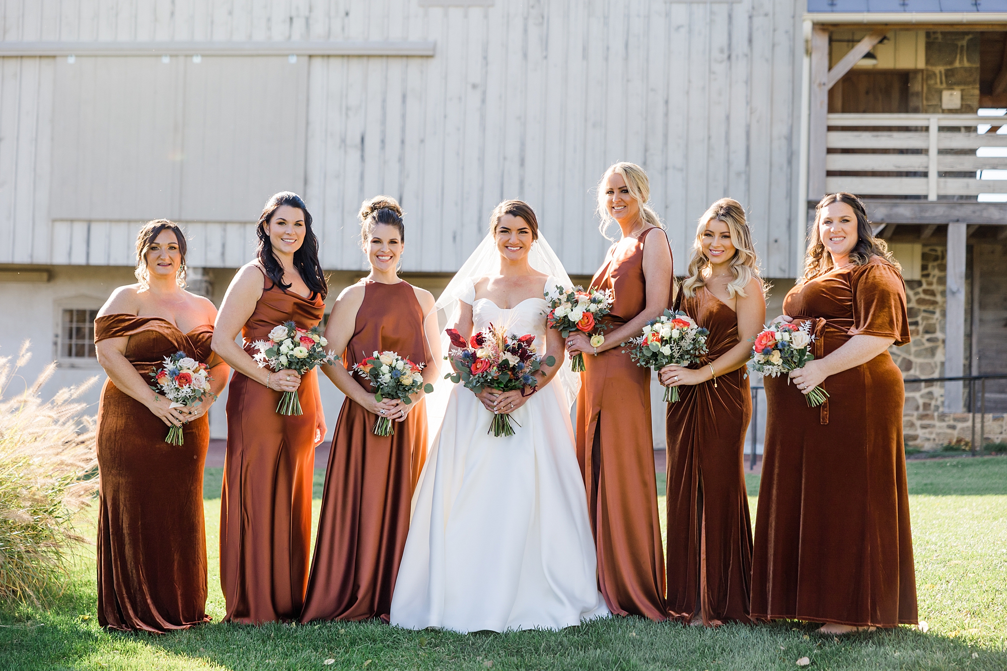 bride and bridesmaids outside of barn at French Creek