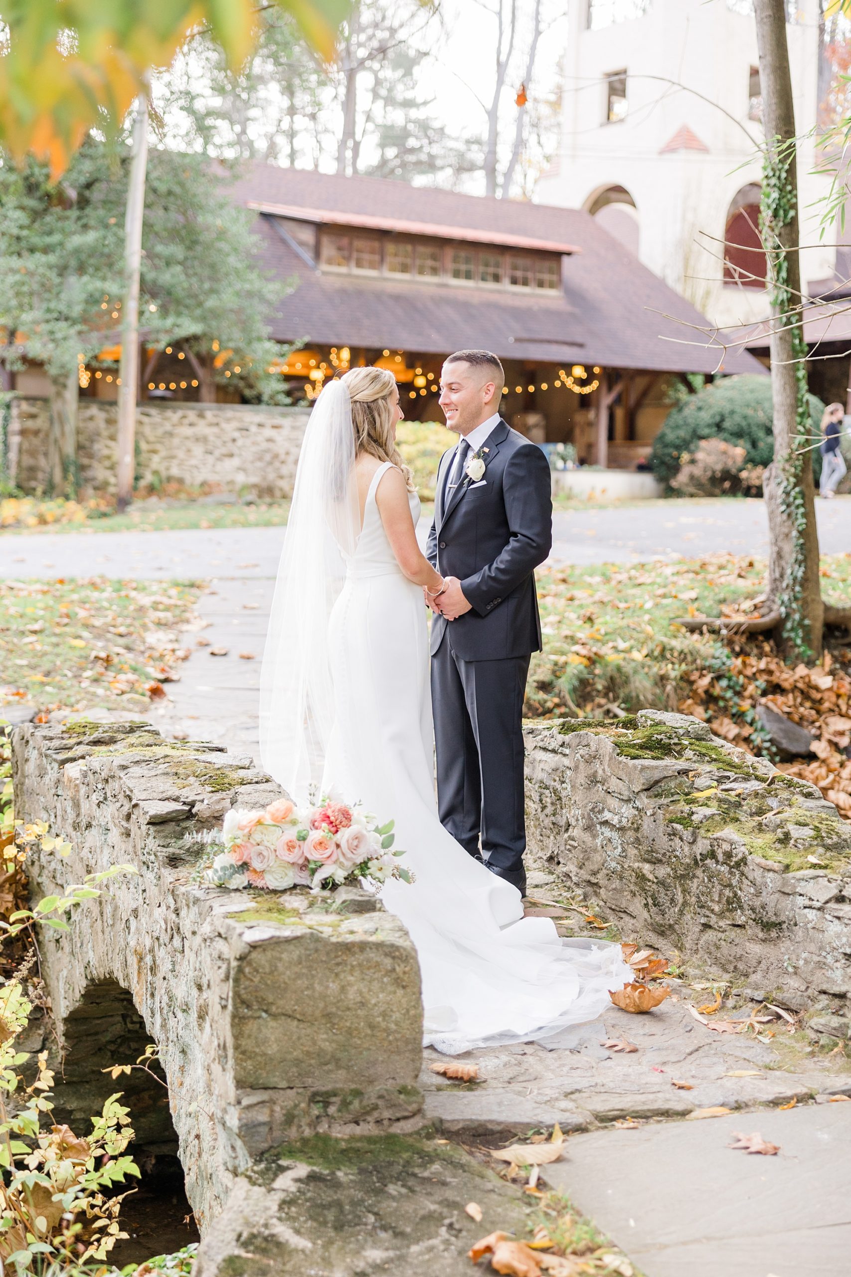 bride and groom on stone bridge at The Old Mill 