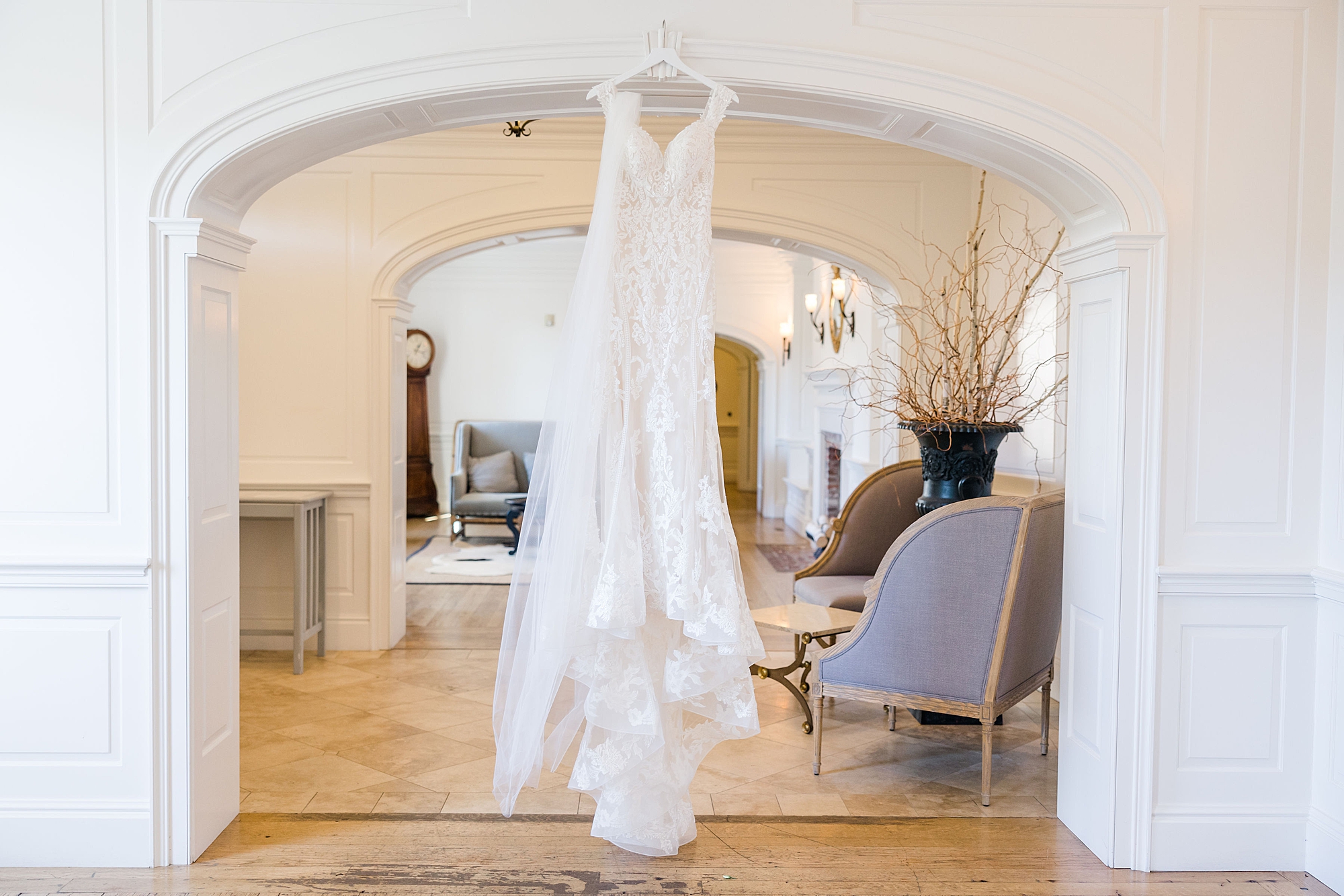 stunning wedding dress hanging in over arch 