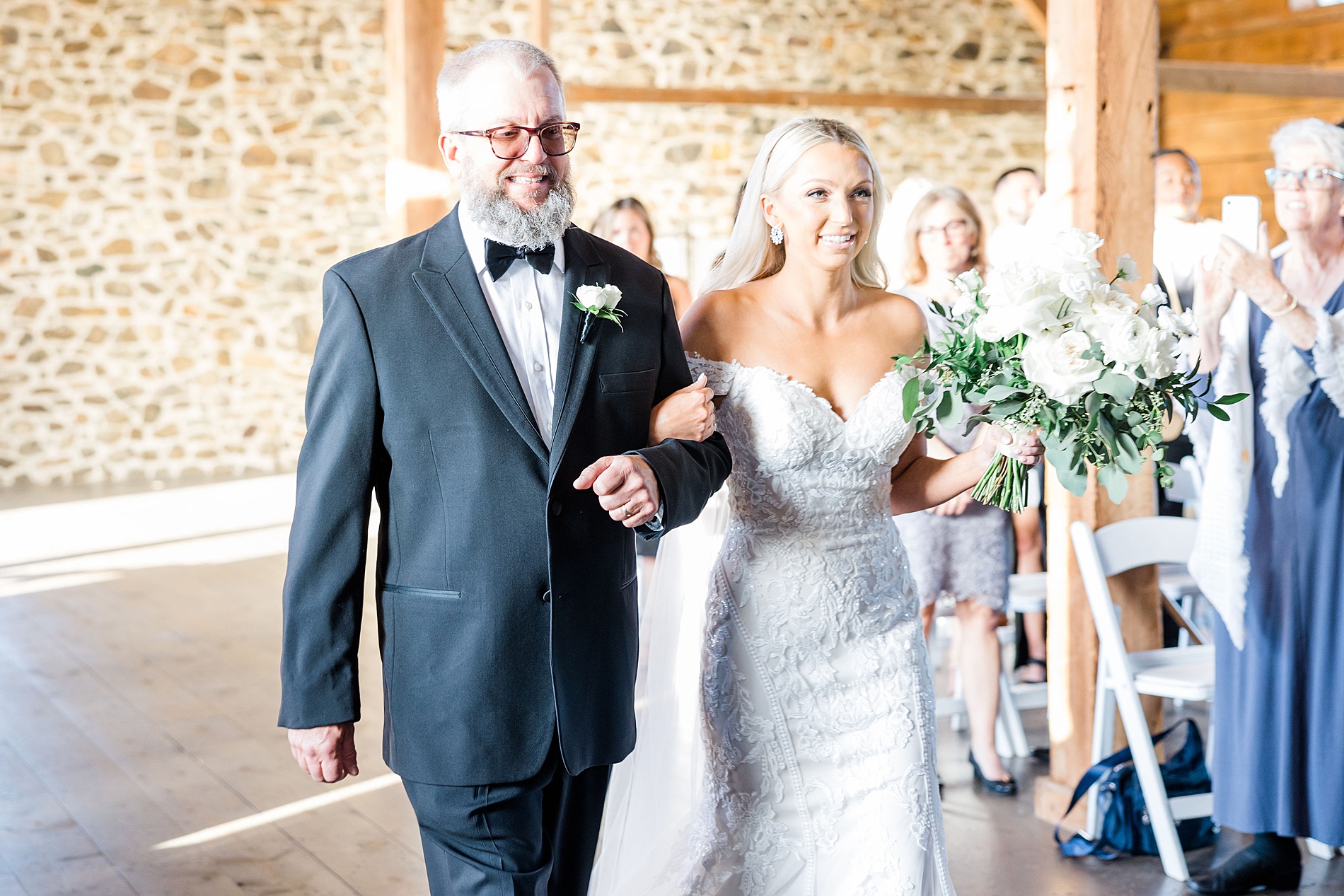bride walking down the aisle with father at Elegant French Creek Wedding