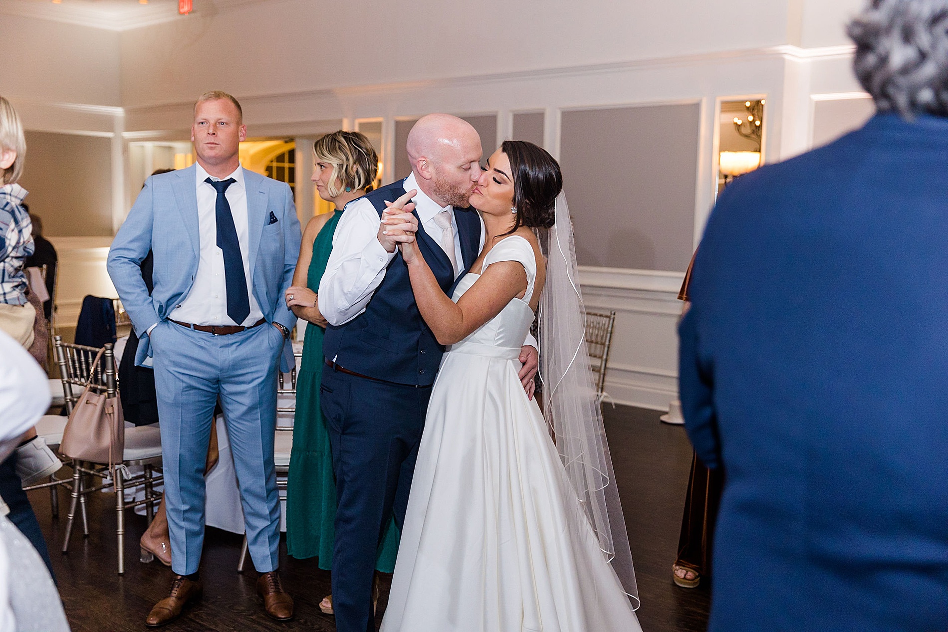 groom kisses his bride from romantic french creek wedding 