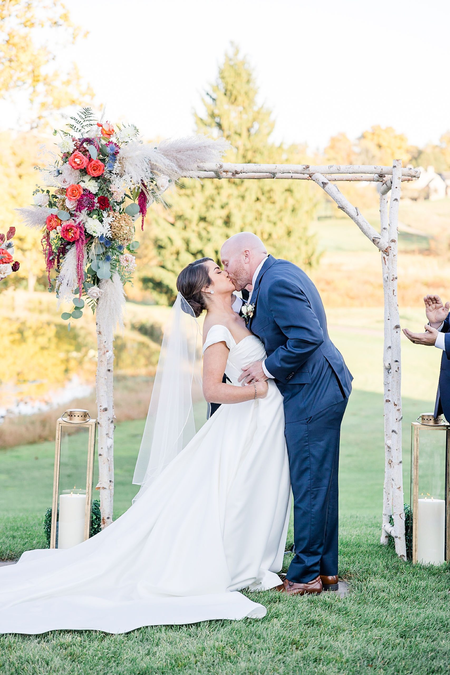 bride and groom kiss at romantic outdoor french creek wedding ceremony