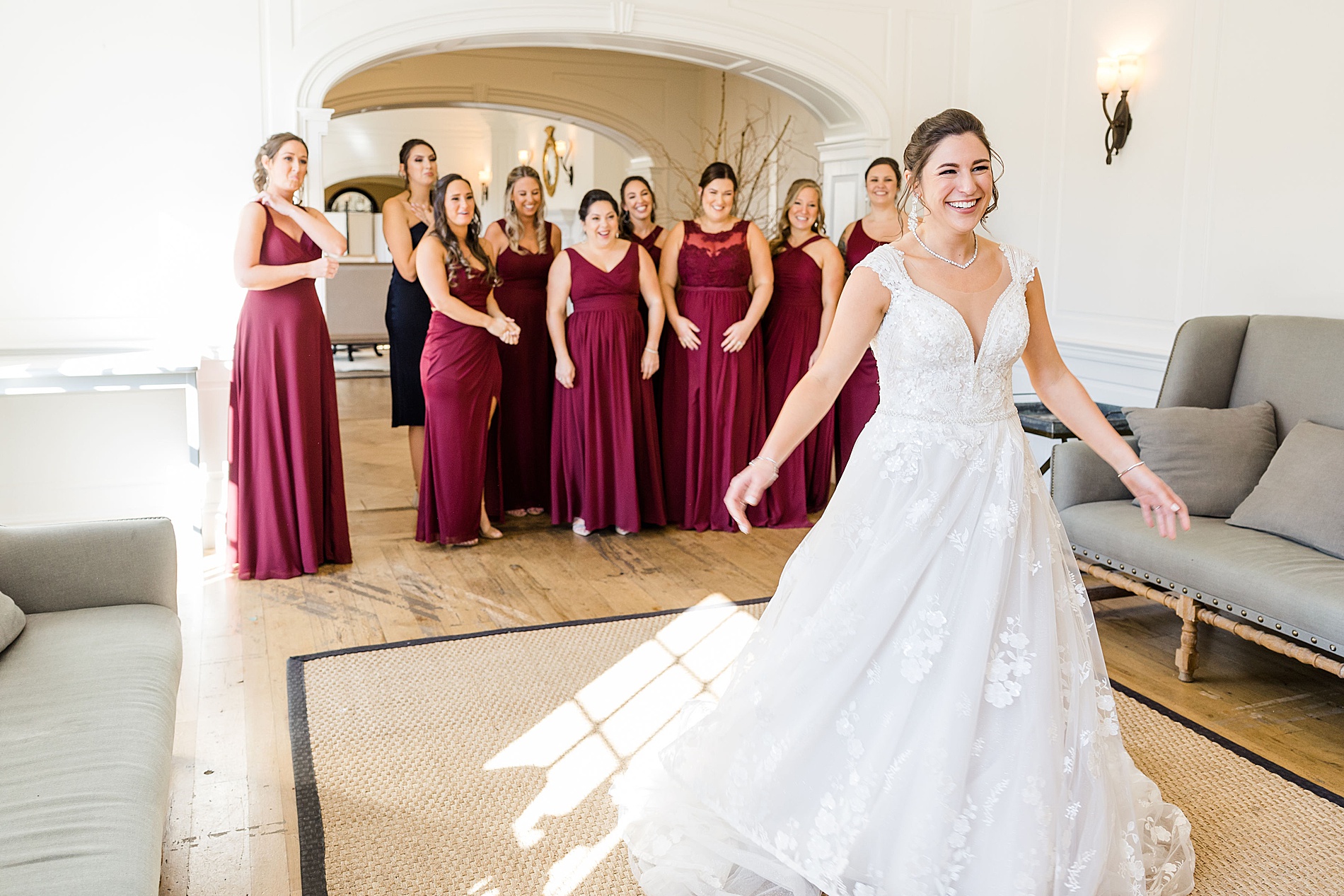bride spins for bridesmaids during first look