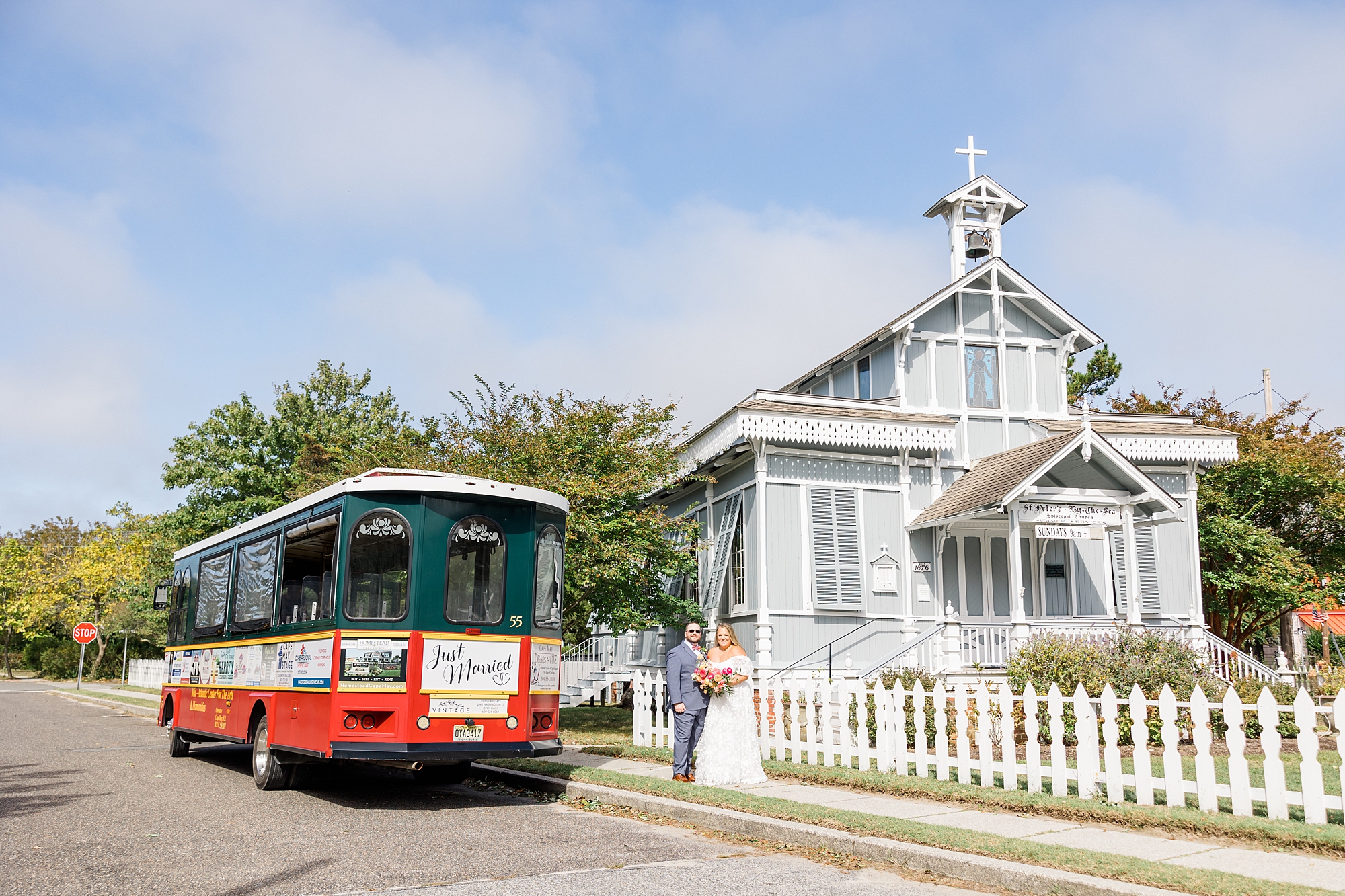 couple in front of trolley by church after Intimate Cape May Wedding ceremony