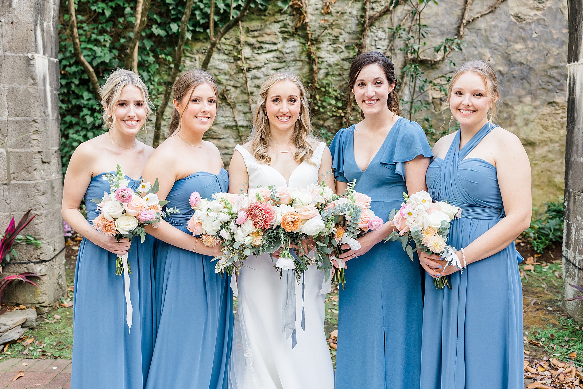 bride and bridesmaids in blue dresses