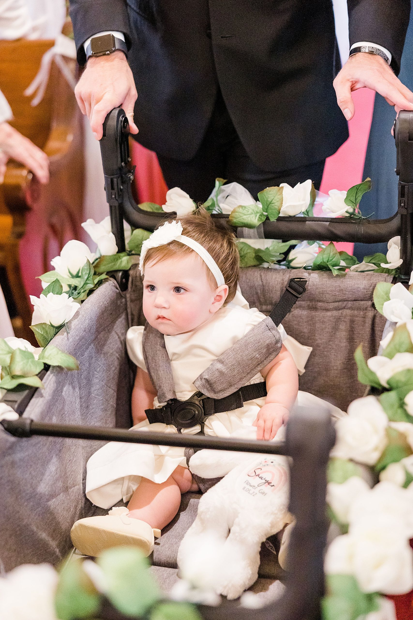 flower girl is escorted down the aisle in wagon