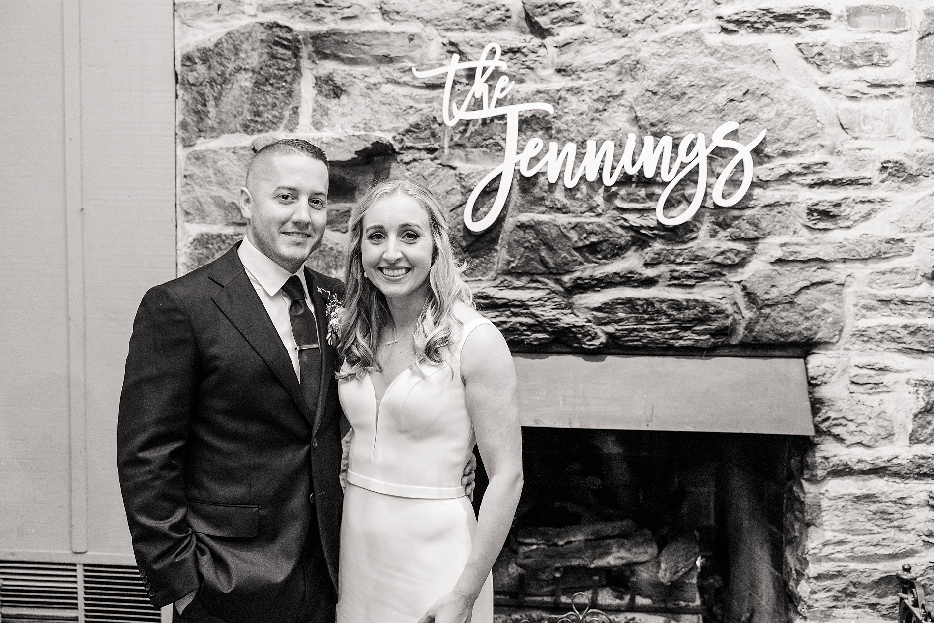 newlyweds pose by last name sign at Old Mill Fall Wedding