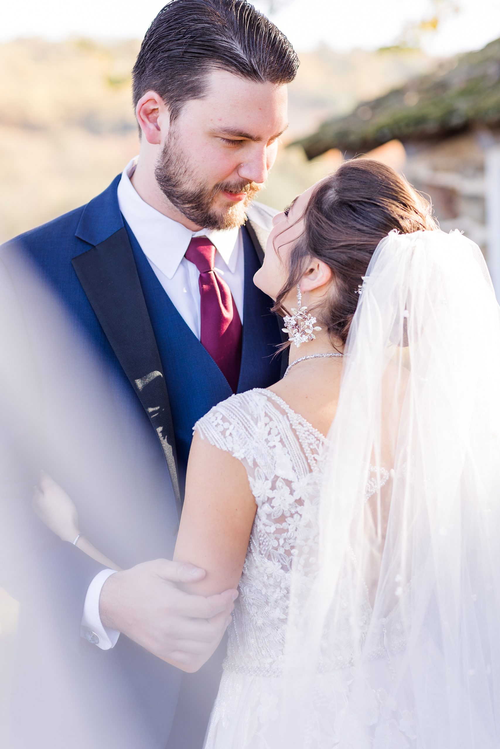 couple looks up to each other during wedding portraits