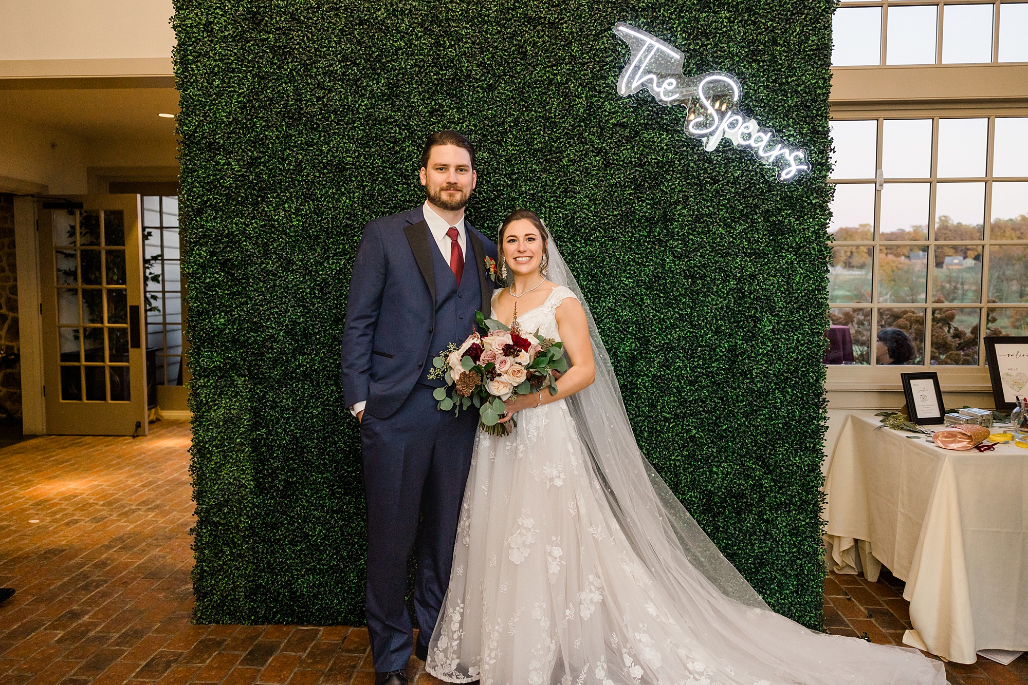 couple by sign at Fall Wedding at French Creek Golf Club 