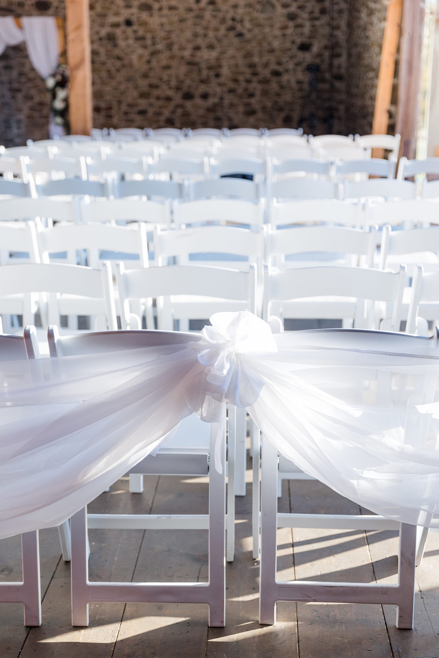 wedding chairs decorated with ribbons