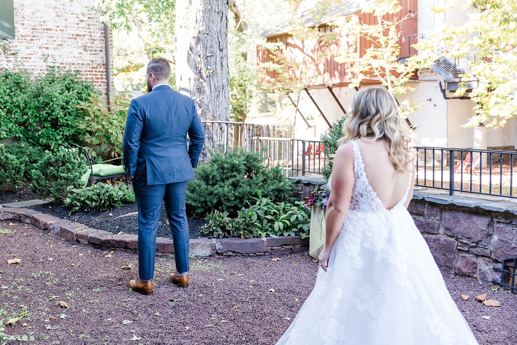 bride walks behind groom for first look 
