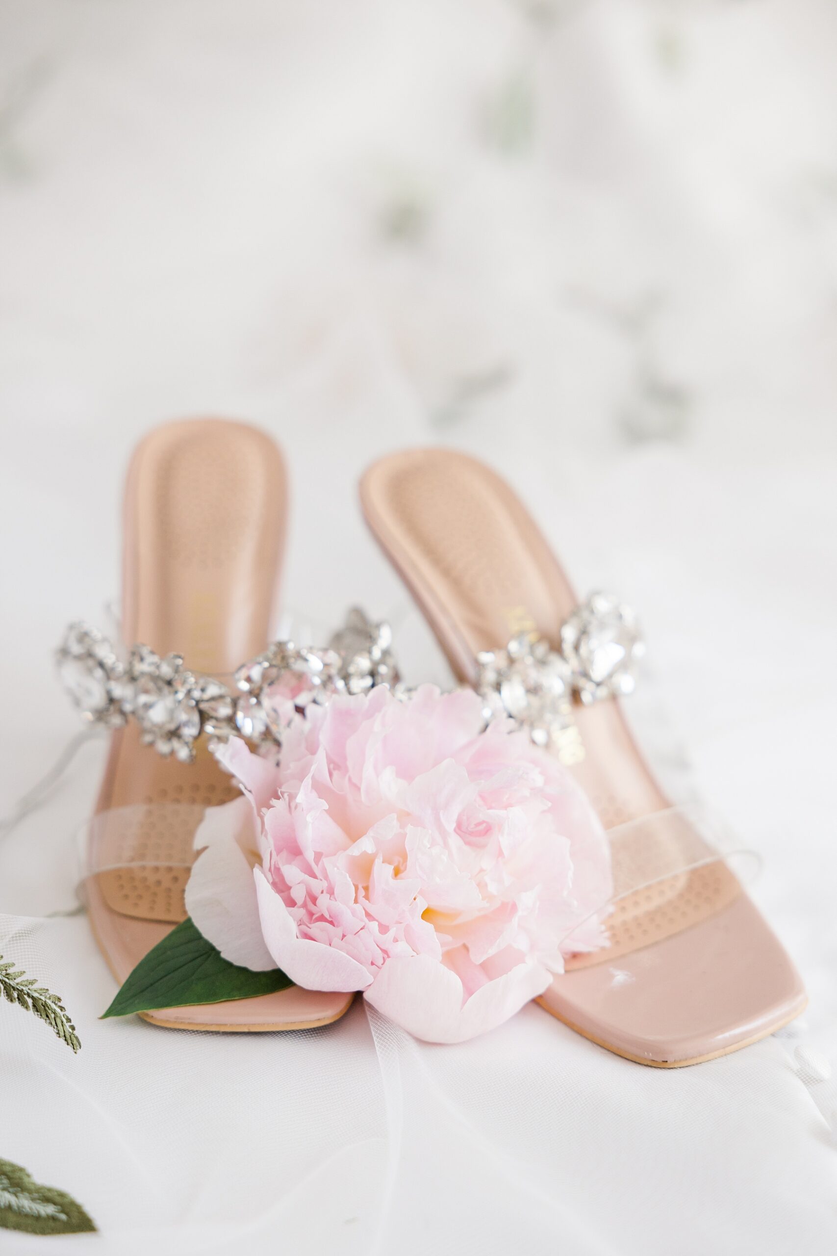 bride's shoes with dusty pink flower