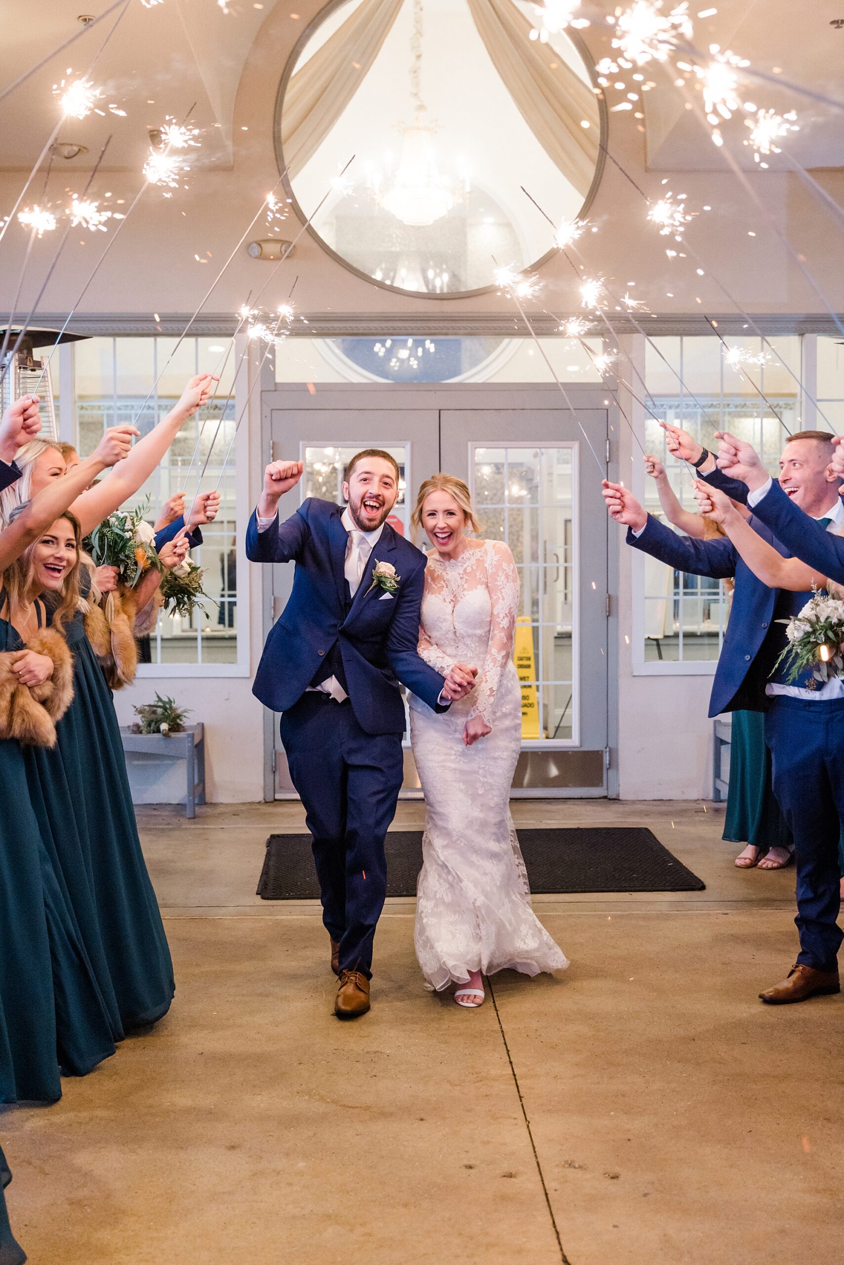 wedding party holds sparklers for newlyweds 