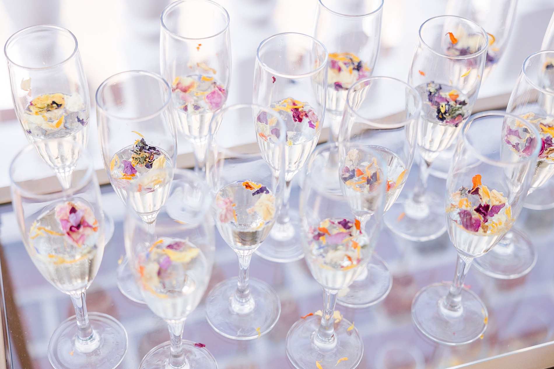 champagne with flowers sprinkled inside from Chic Garden Wedding at Baywood Greens