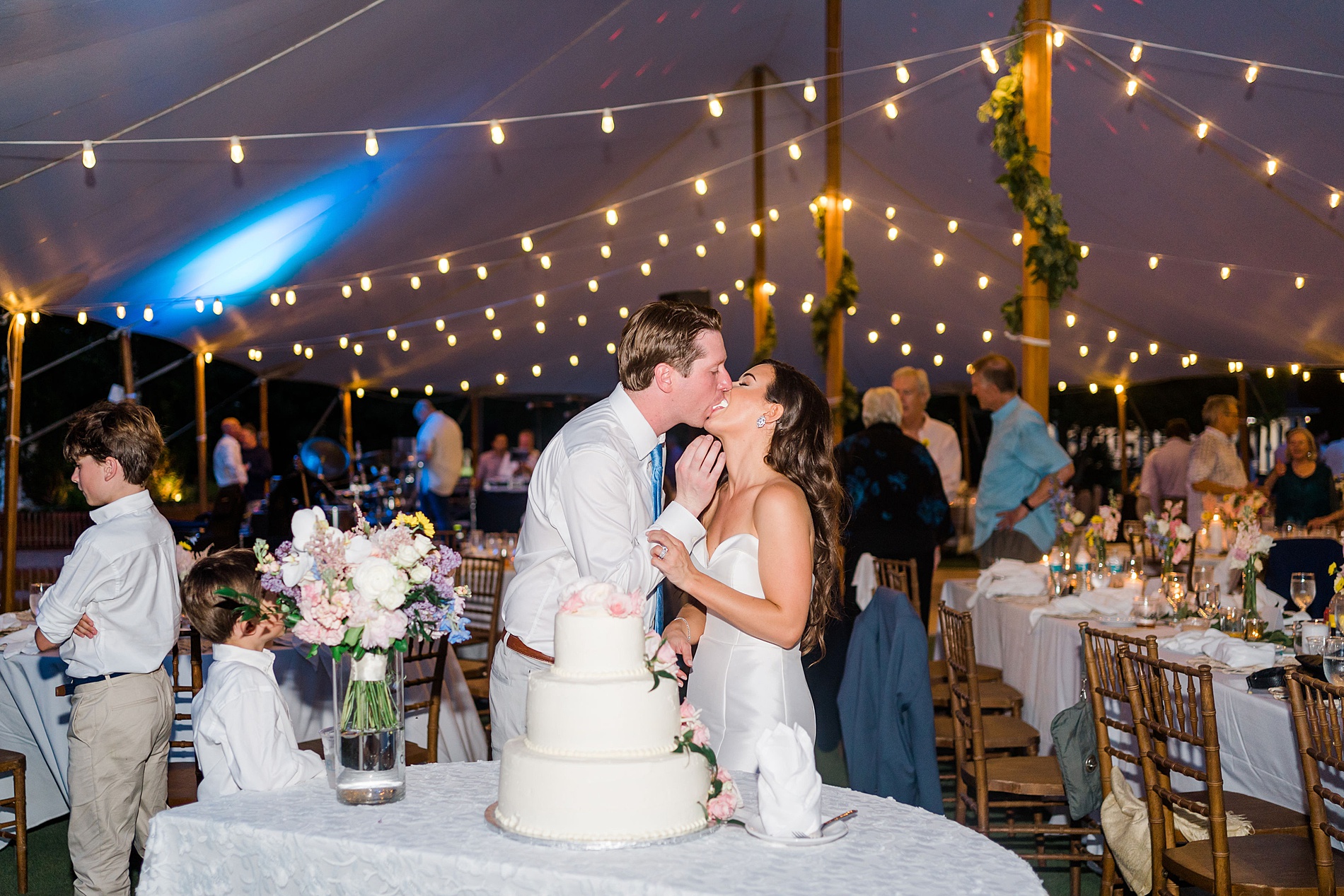 couple kiss during wedding reception