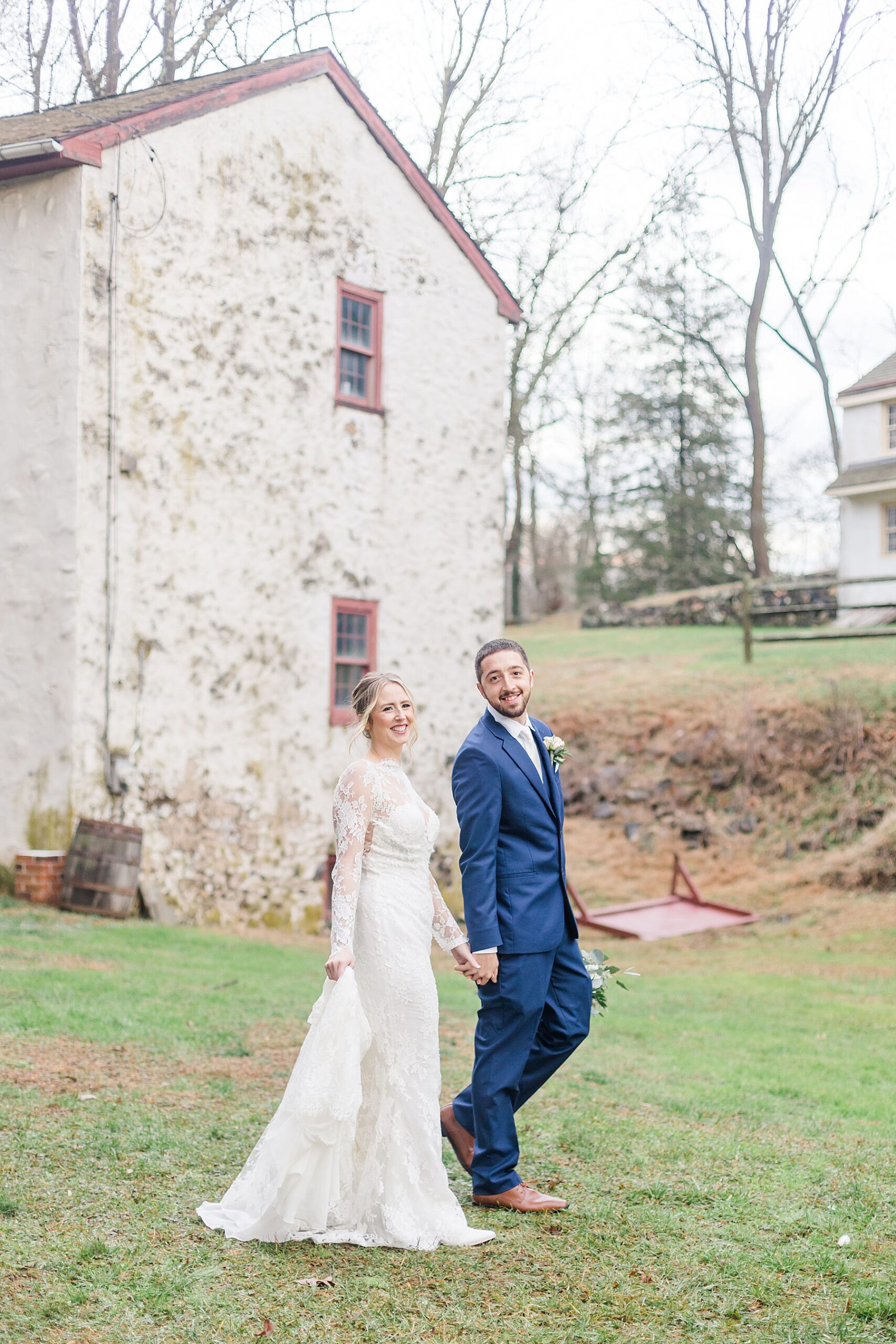 couple walking wedding venue holding hands in Glen Mills, PA