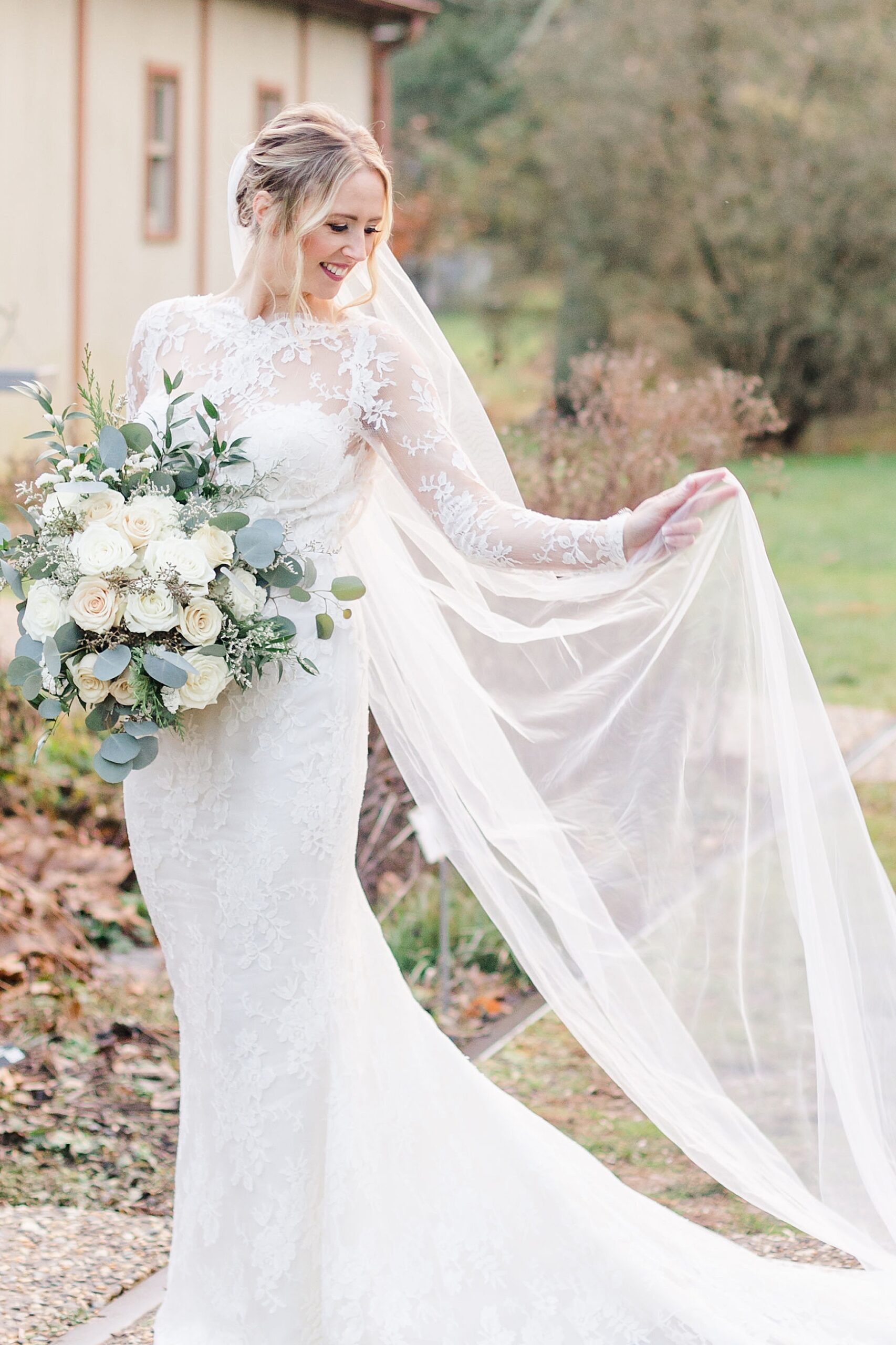 bride in wedding dress holding white rose bouquet