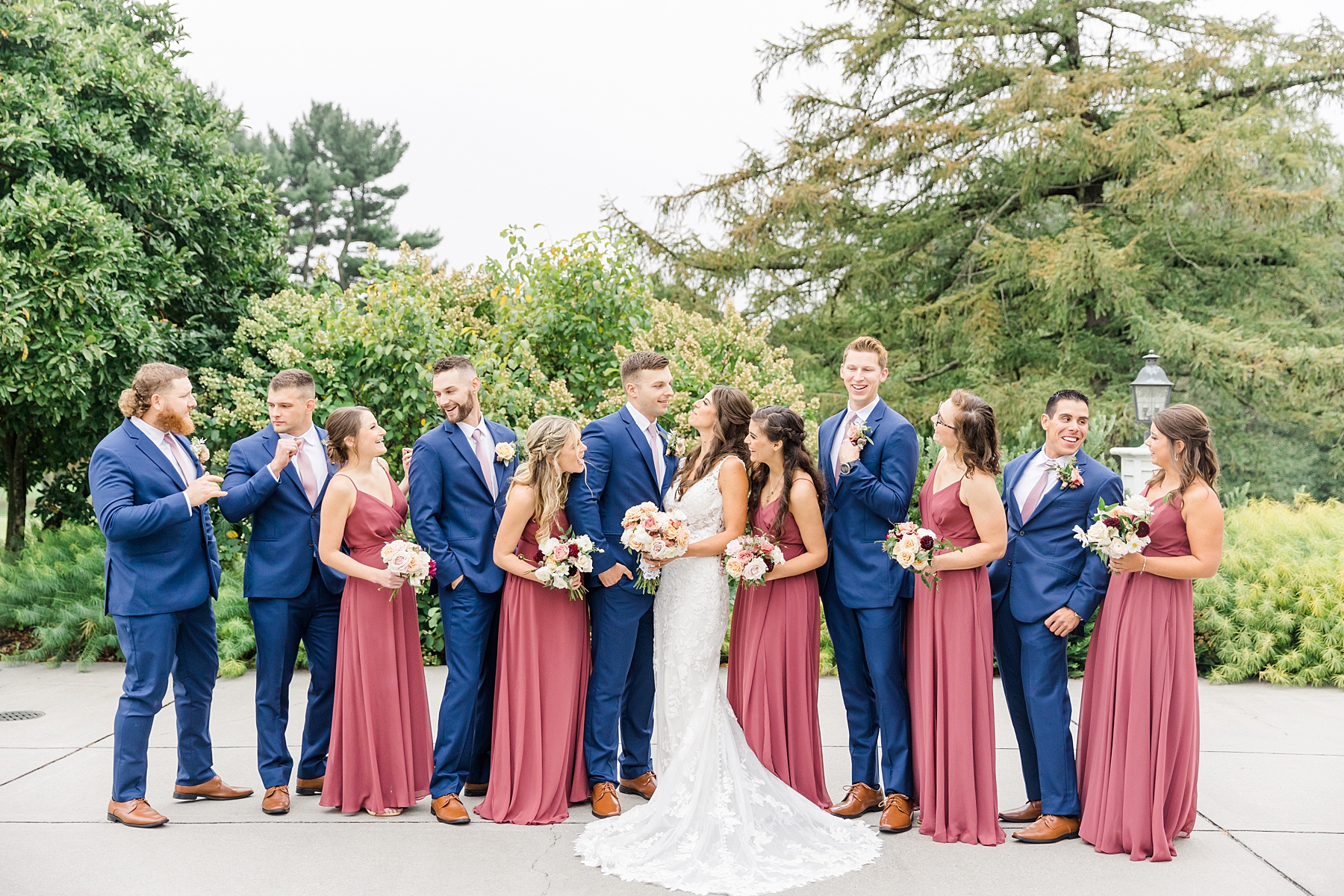 bridesmaids in rosewood dresses and groomsmen in navy suits
