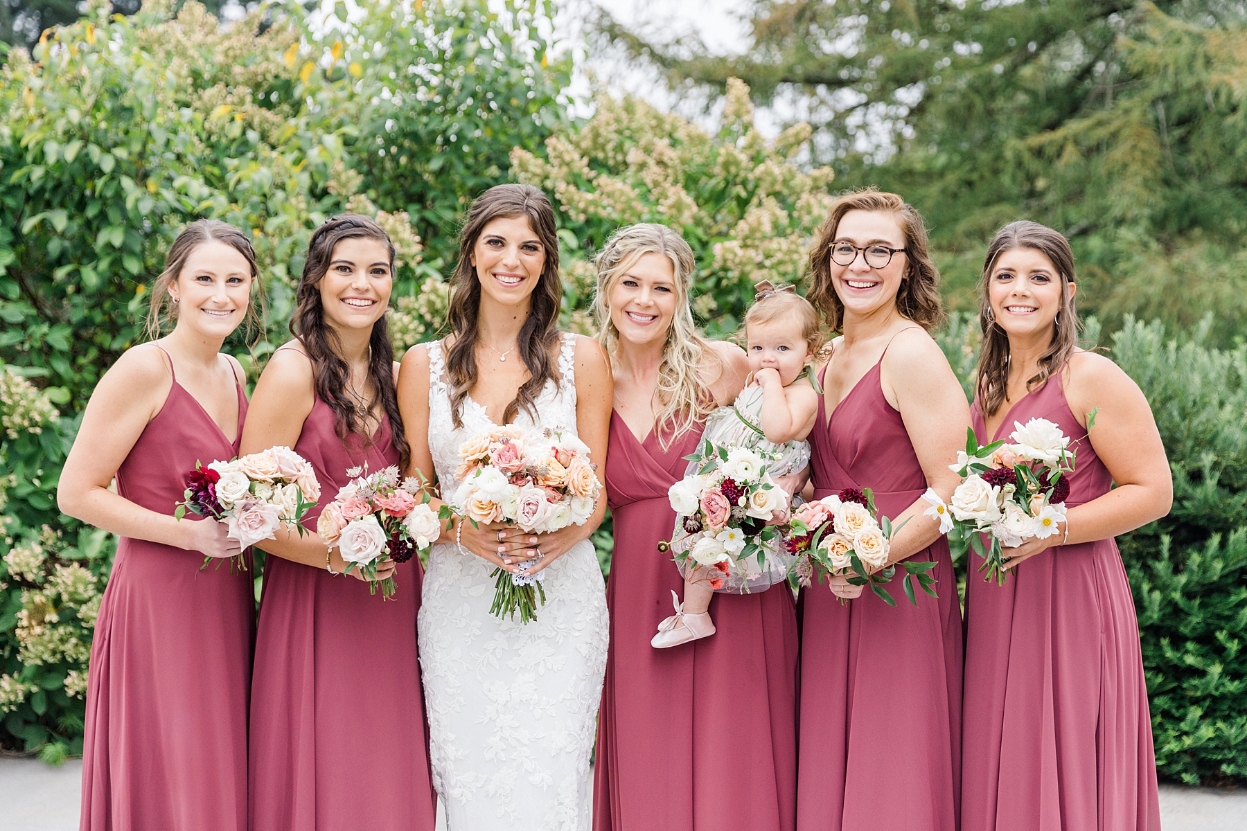 bride and bridesmaids holding romantic wedding bouquets