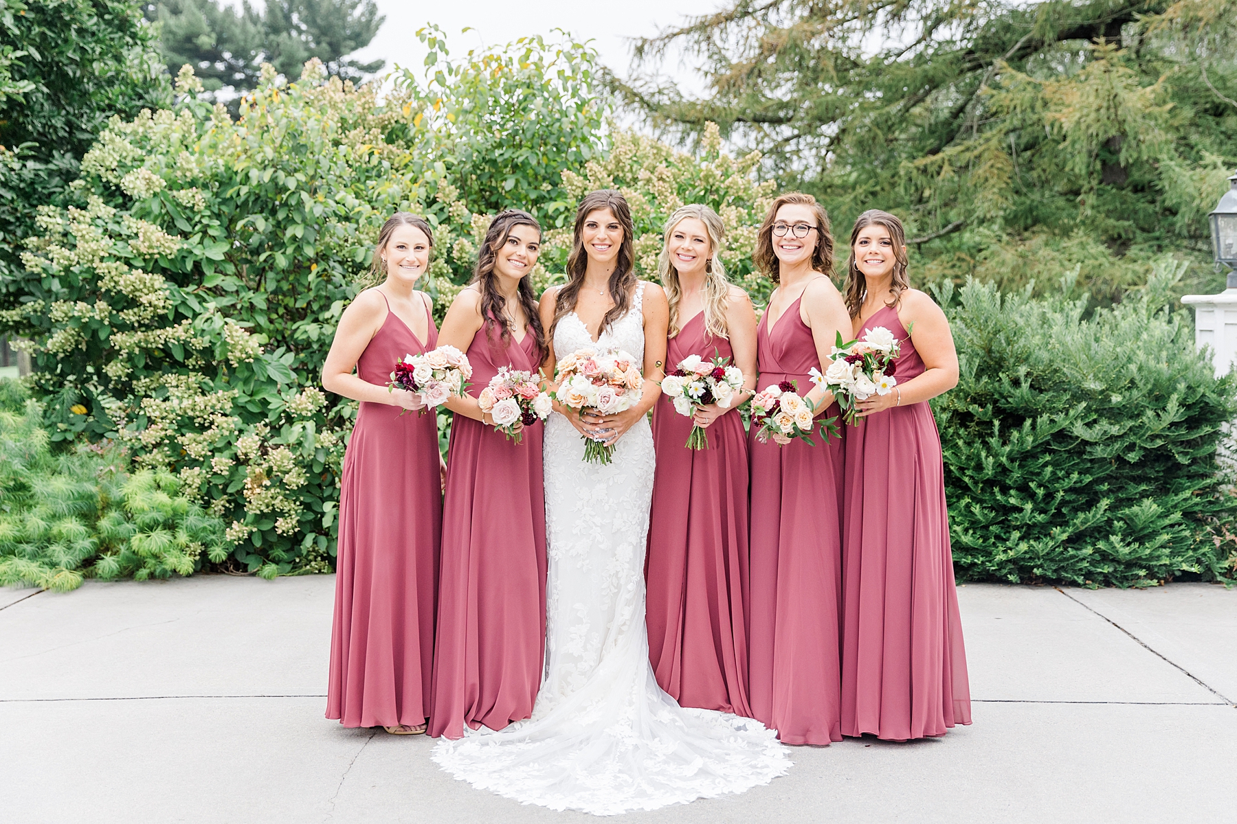 bride and bridesmaids in rosewood colored dresses