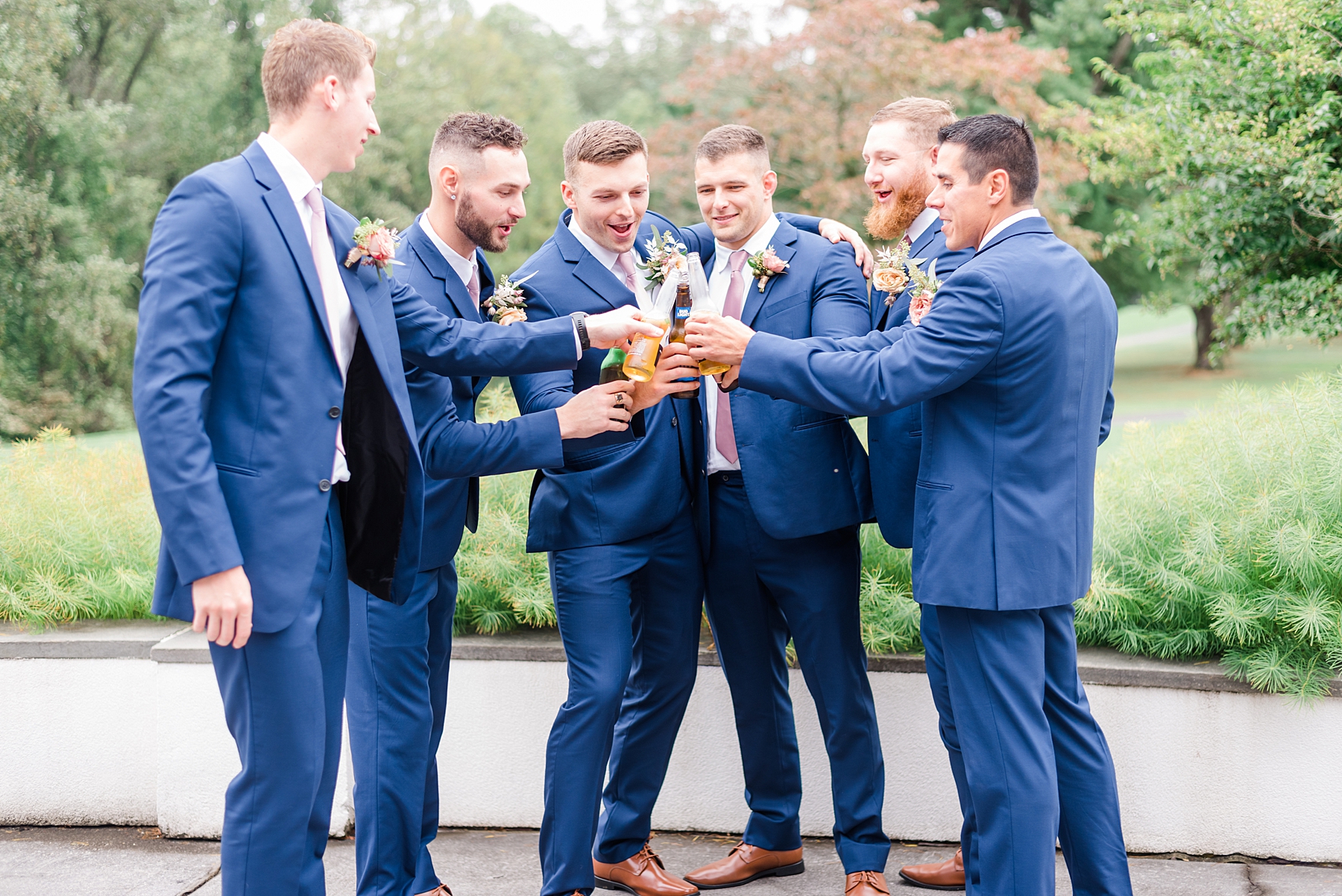 groom and groomsmen cheers together before ceremony