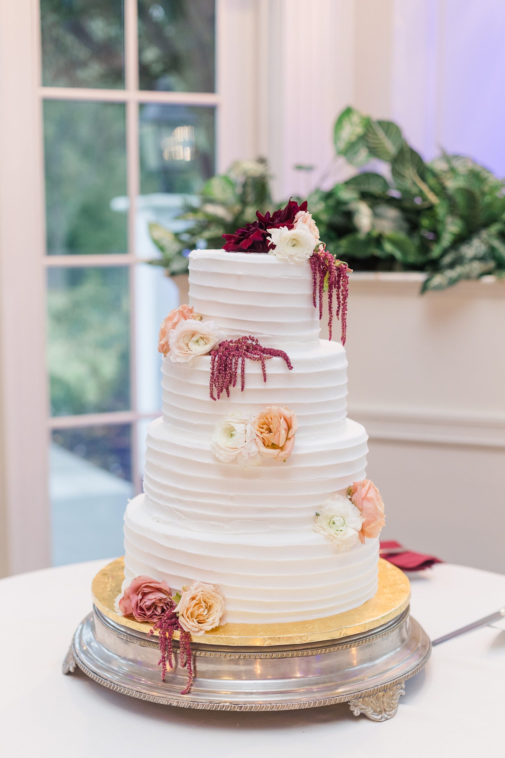 4 tiered wedding cake with flowers 