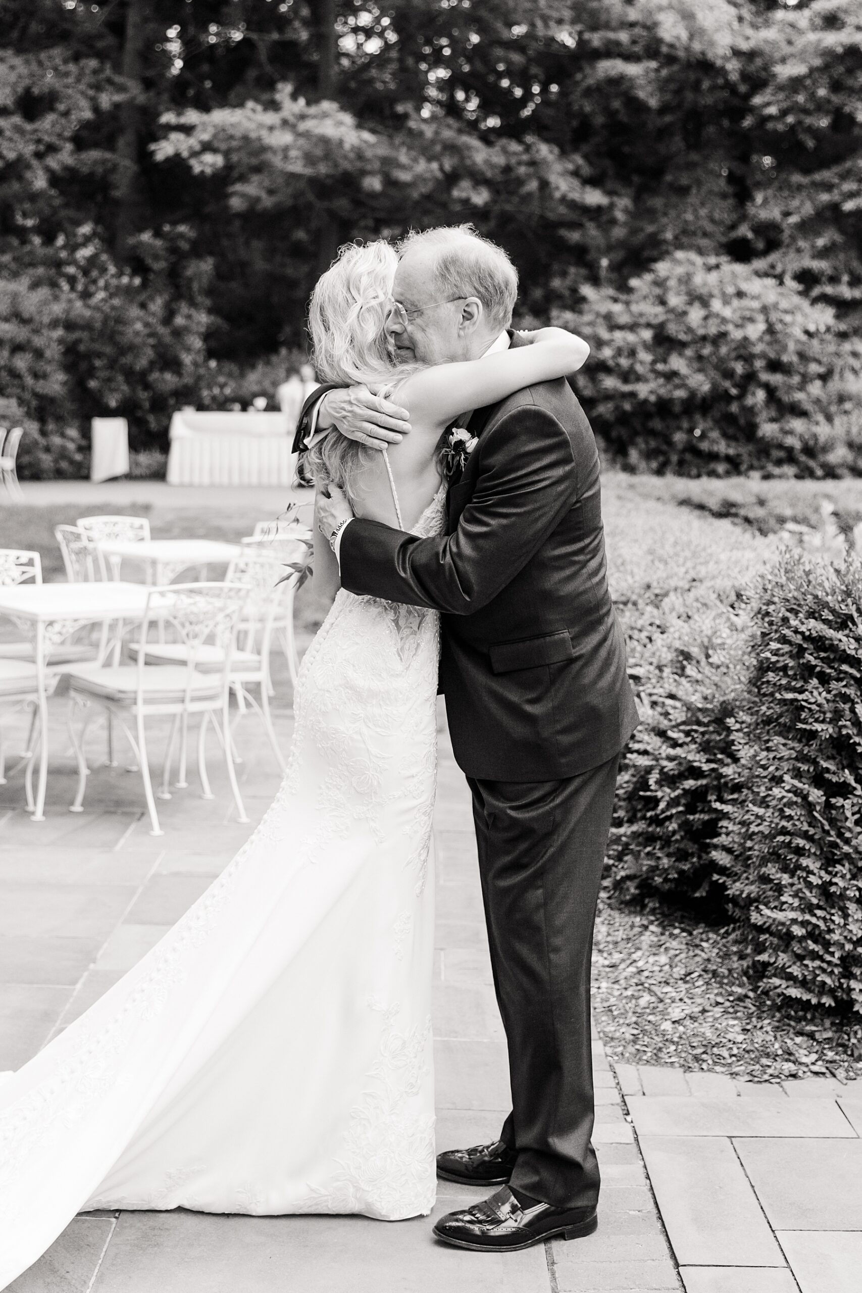 bride hugs her father during first look