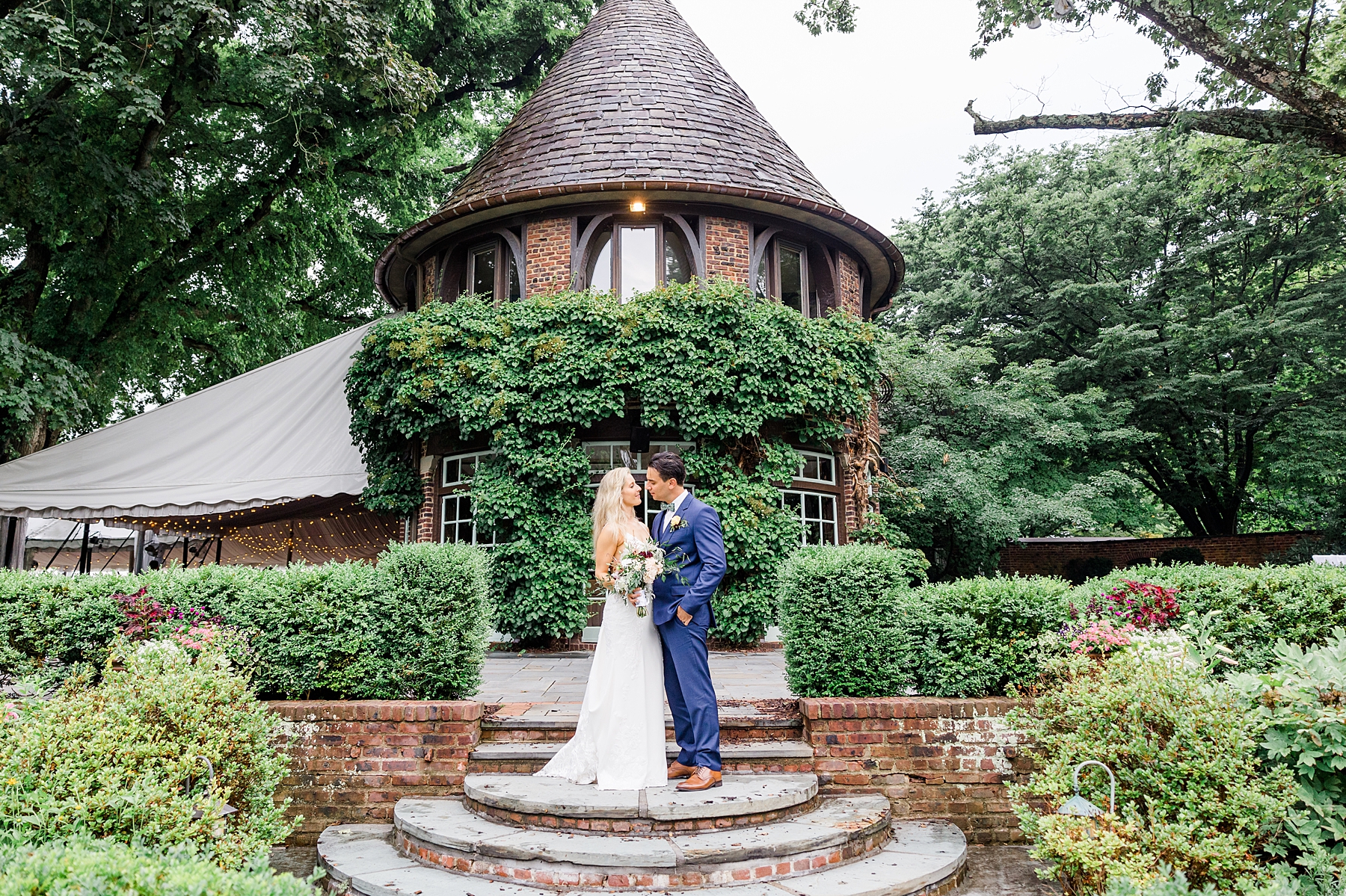 couple kiss in the enchanting garden at Greenville Country Club