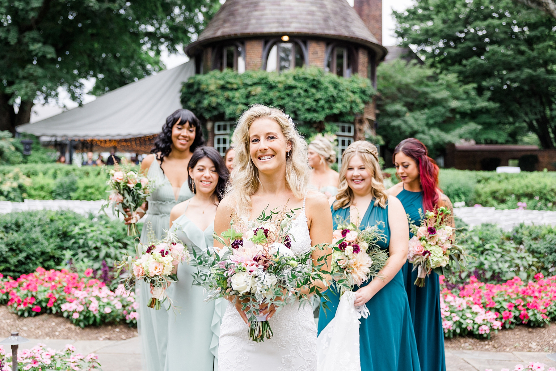 bride with bridesmaids carrying summer garden bouquets