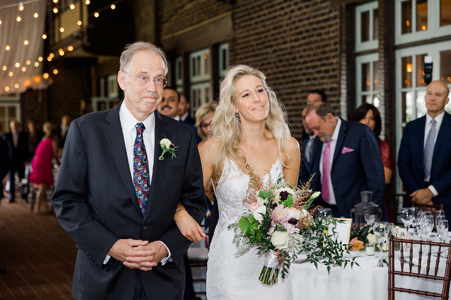 bride walks down the aisle with father
