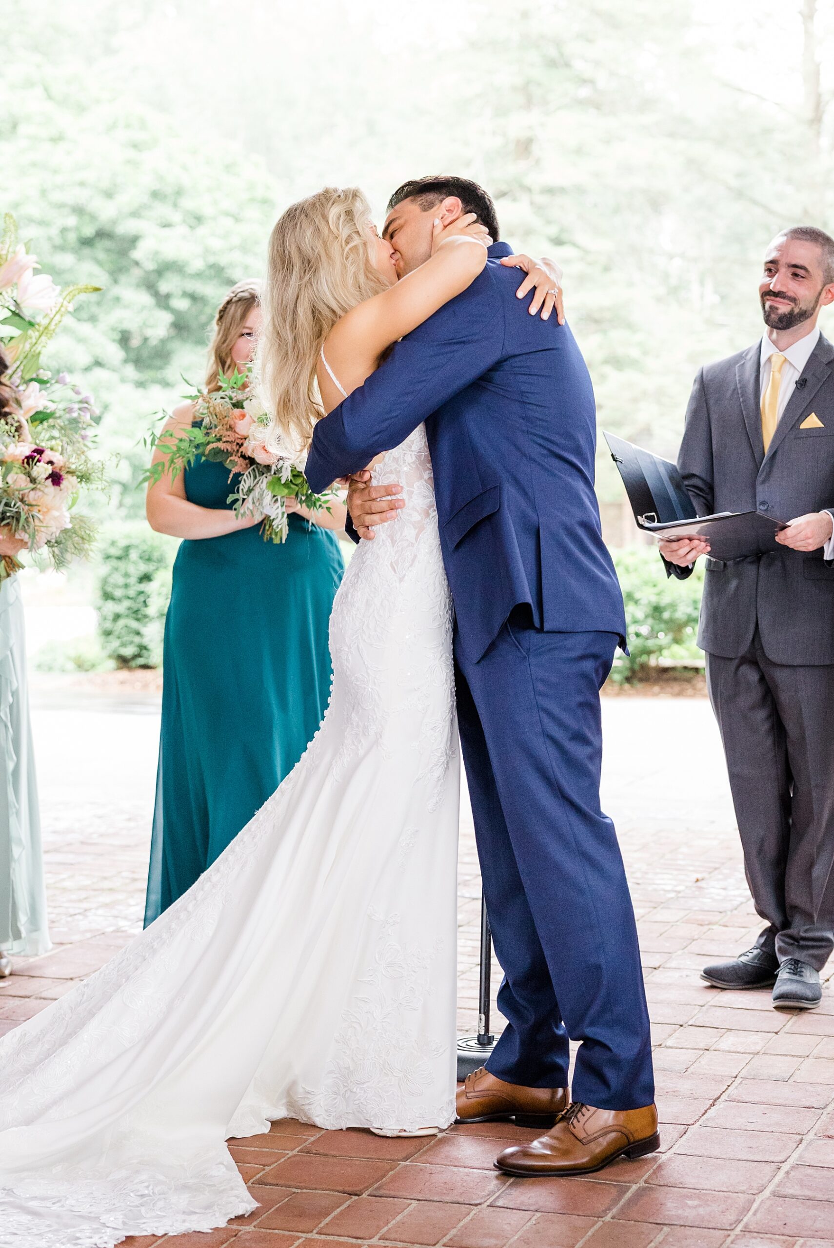newlyweds kiss as wedding ceremony