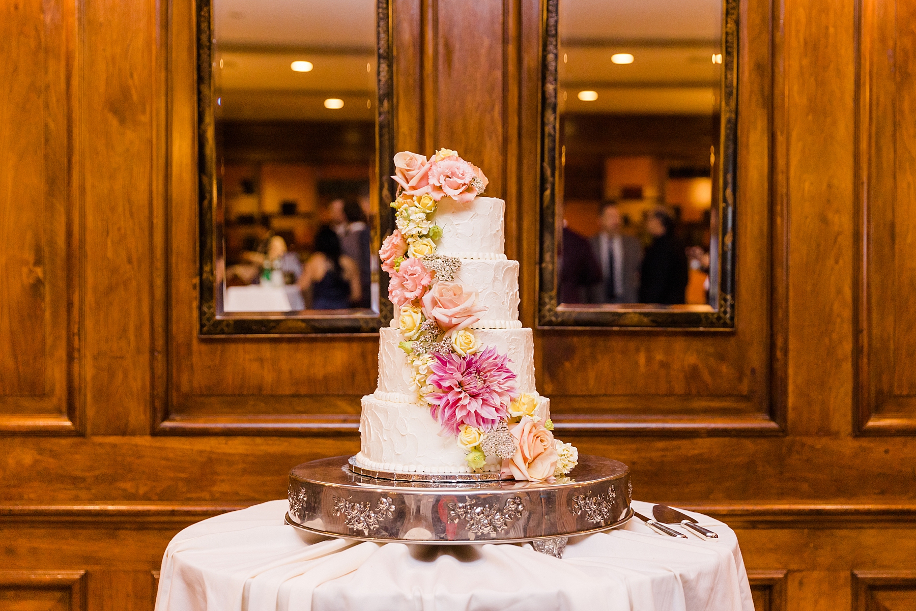 four tiered wedding cake with cascading flower details 