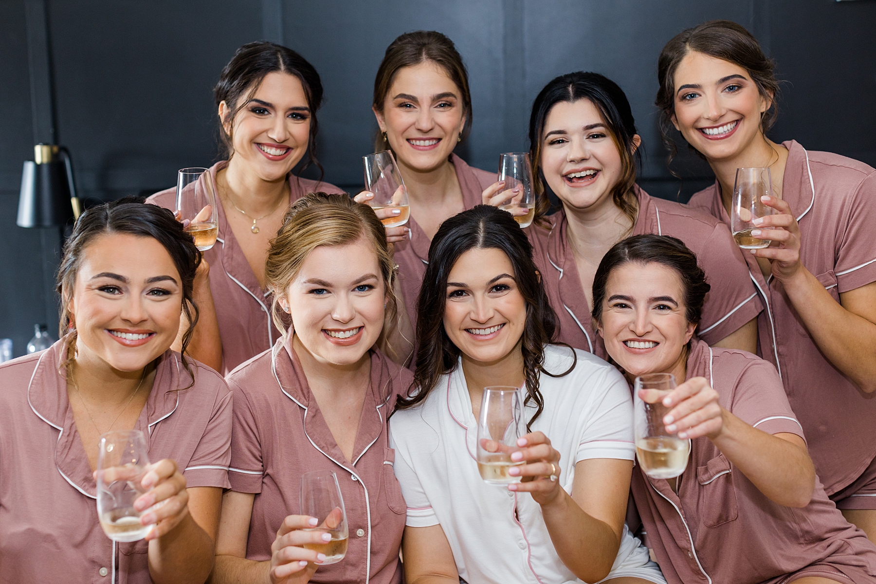 bride and bridesmaids toasting as they get ready