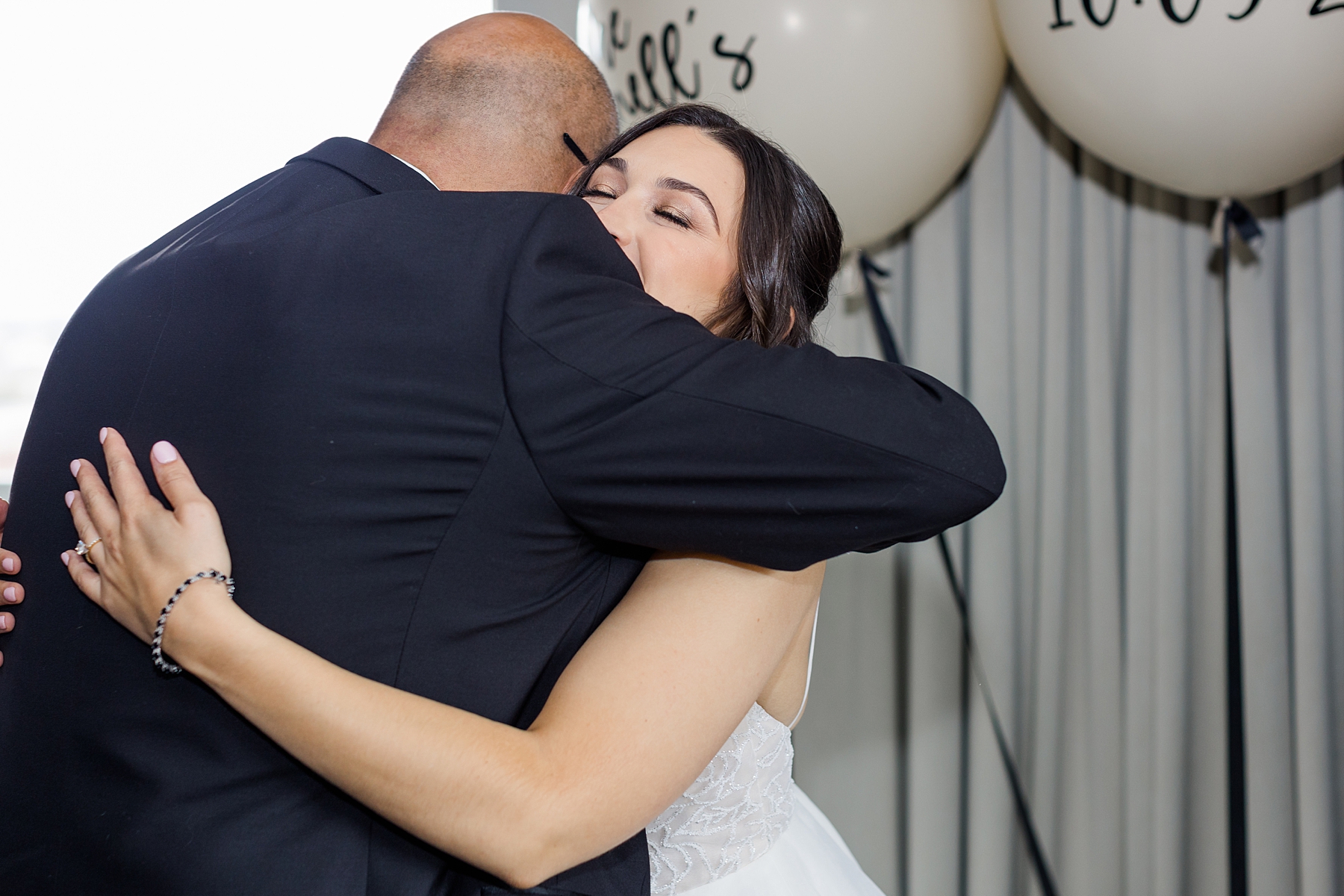 dad hugs his daughter during first look