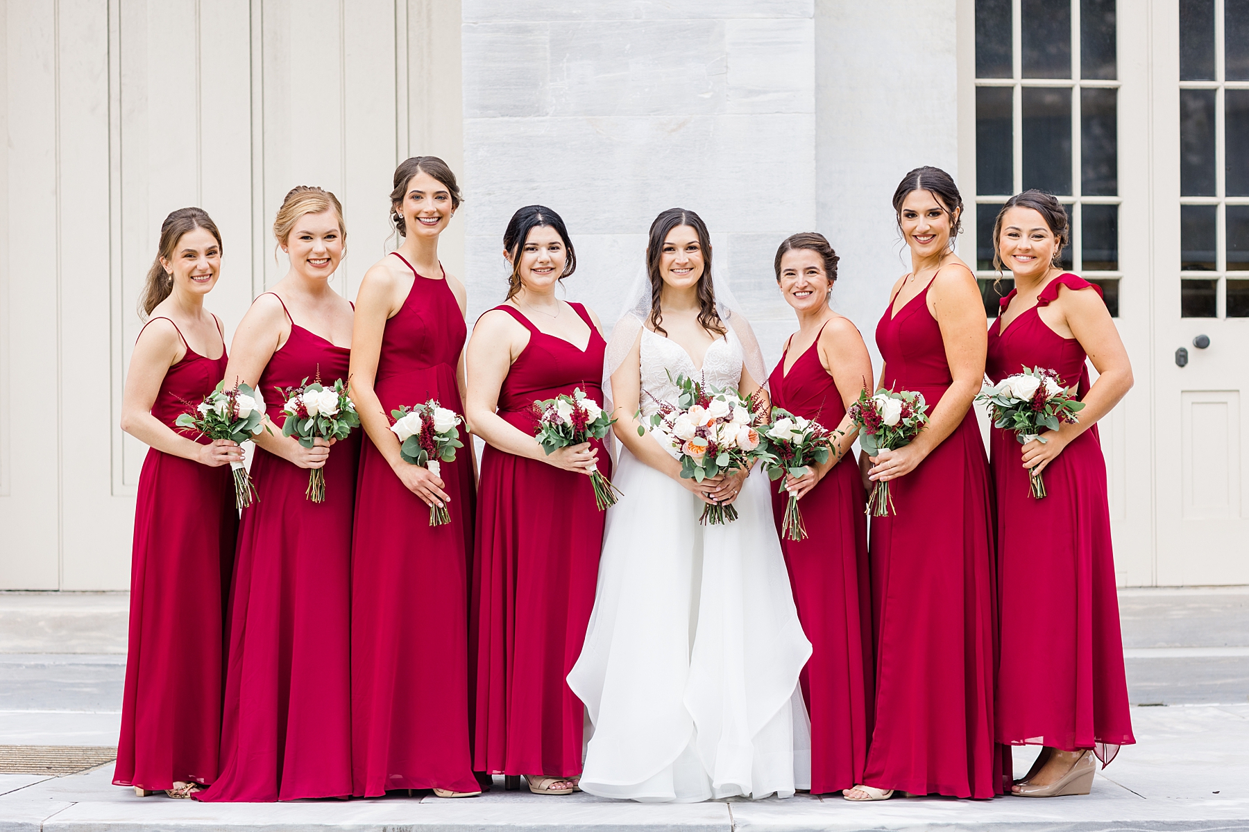 bride and bridesmaids in red dresses before elegant The Down Town Club Wedding 