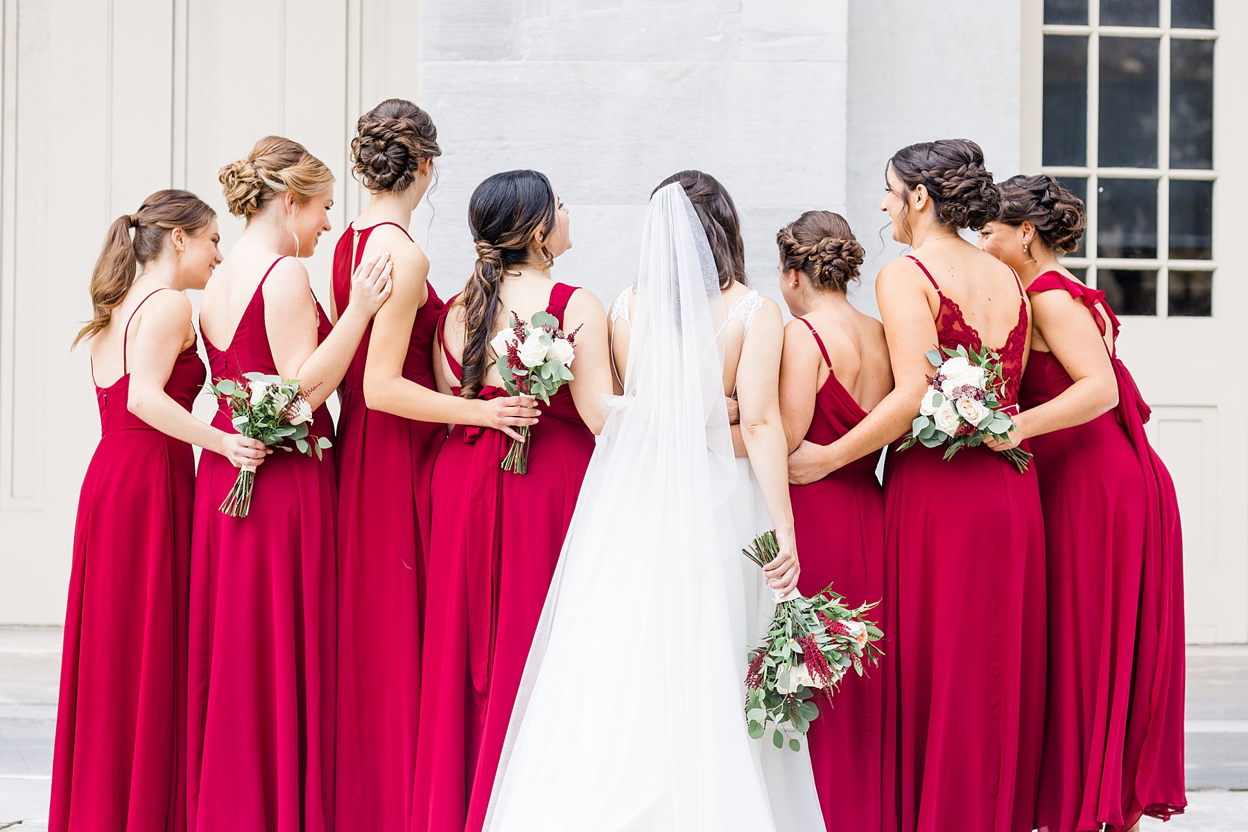 bridesmaids in red dresses with bride 