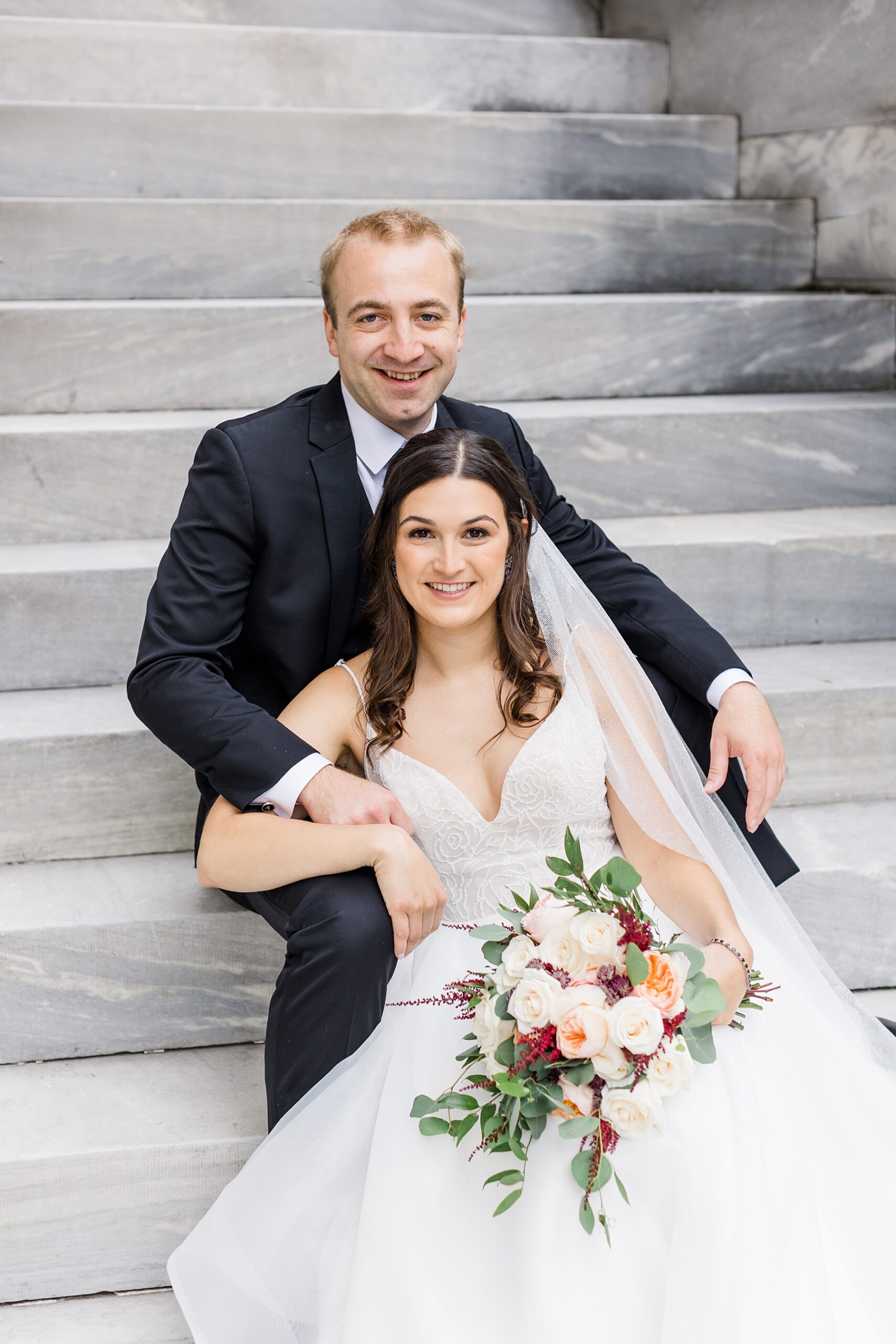 wedding portraits of couple sitting on stairs