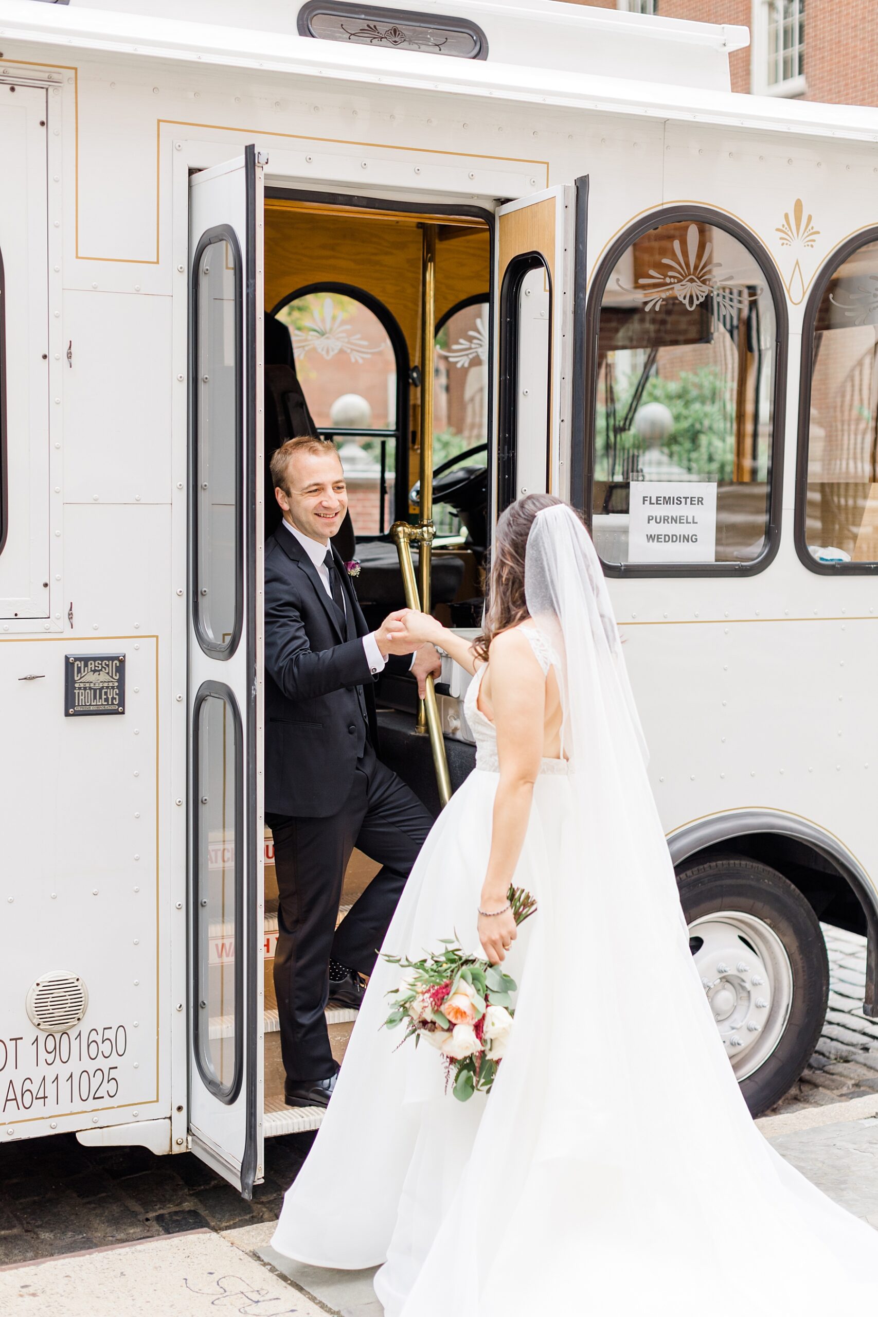 groom helps bride onto bus to go to The Down Town Club Wedding ceremony 
