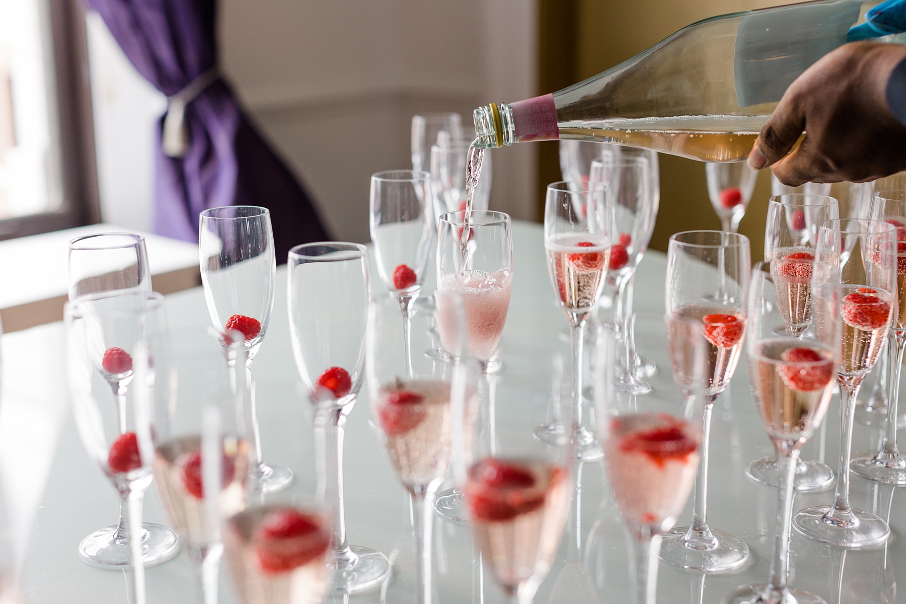 champagne drinks with raspberries for wedding guests