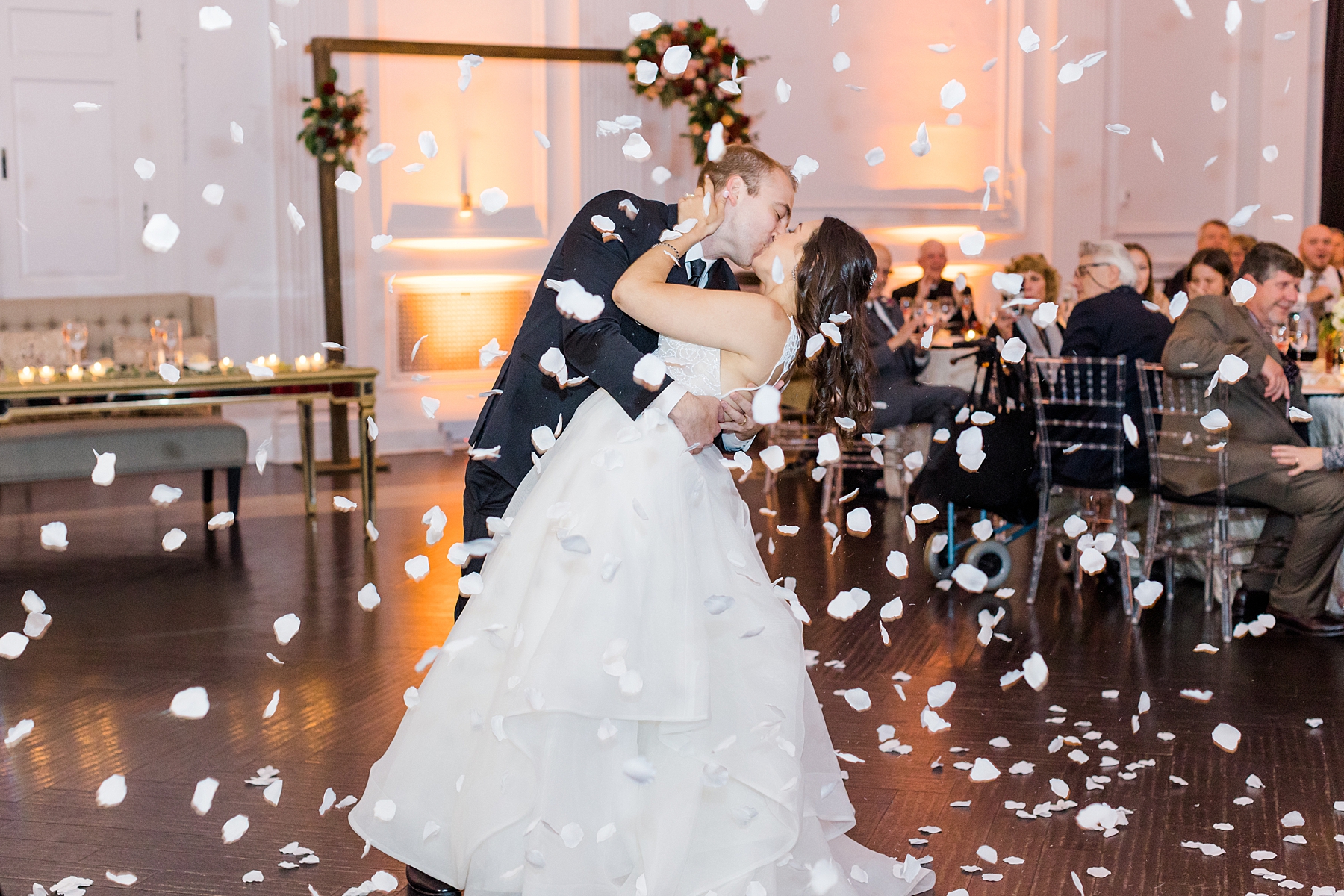 petal cannon sends rainfall of flowers around newlyweds on dance floor  