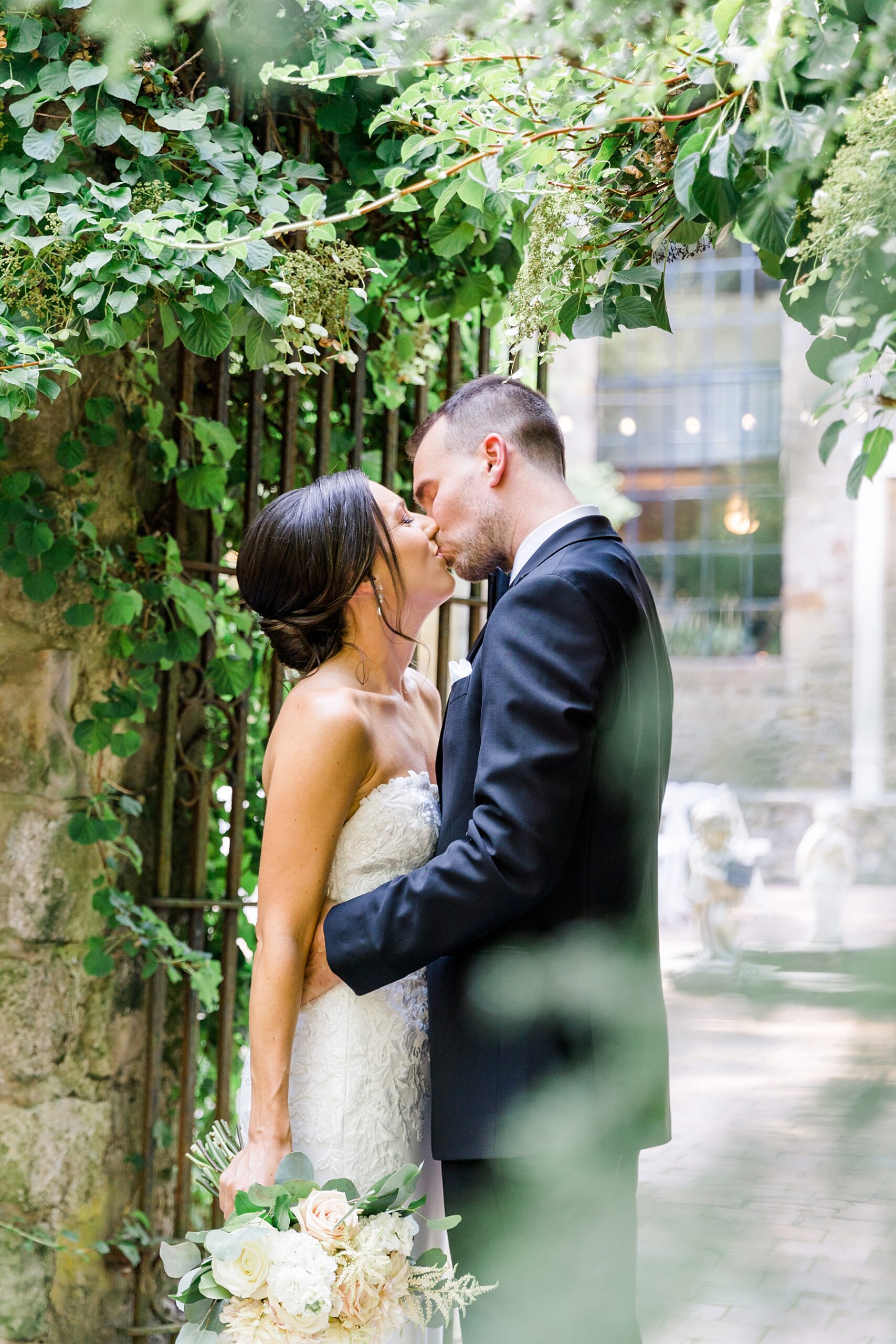 bride and groom kiss during Elegant HollyHedge Estate Wedding portraits