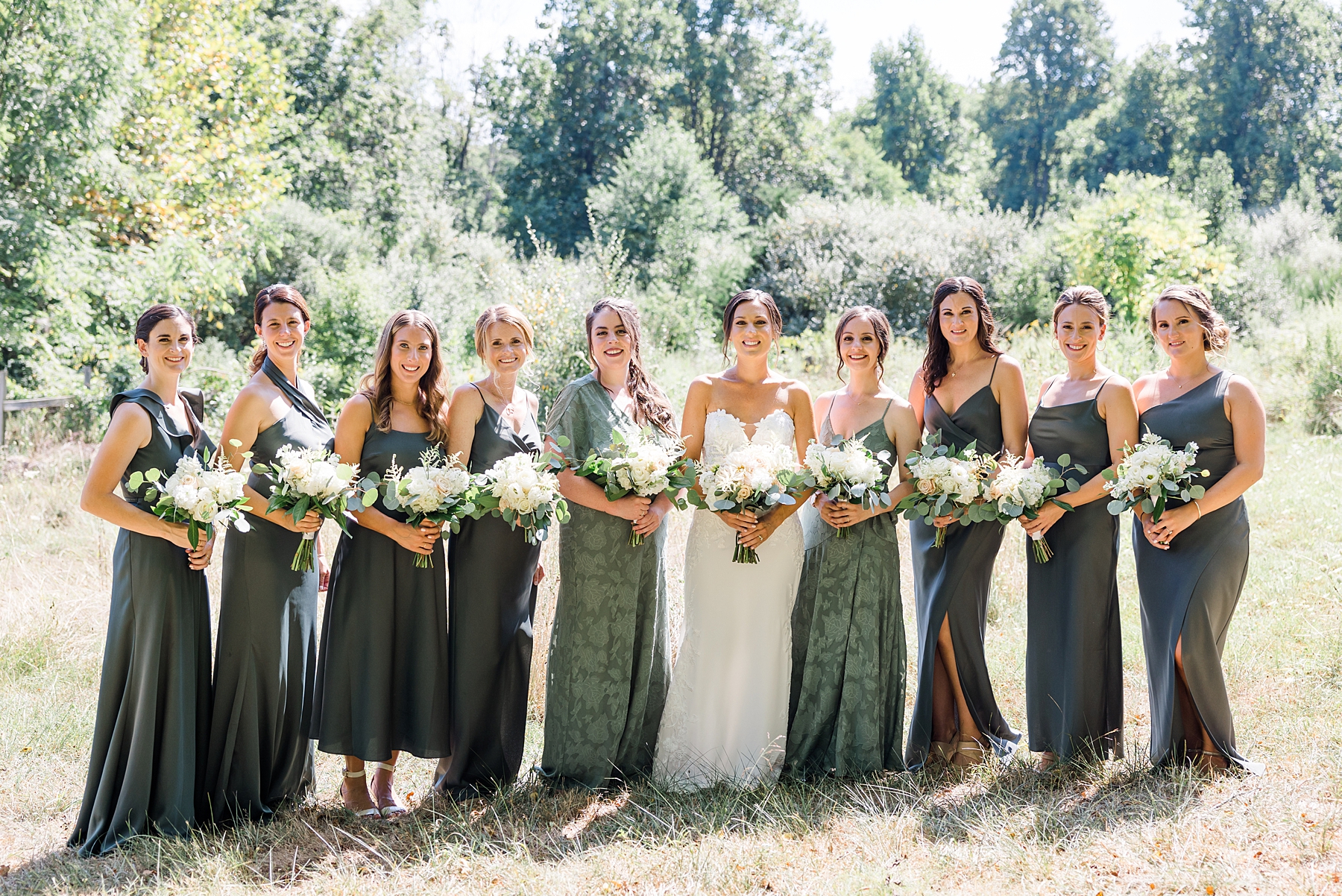 bride with her wedding party in sage dresses